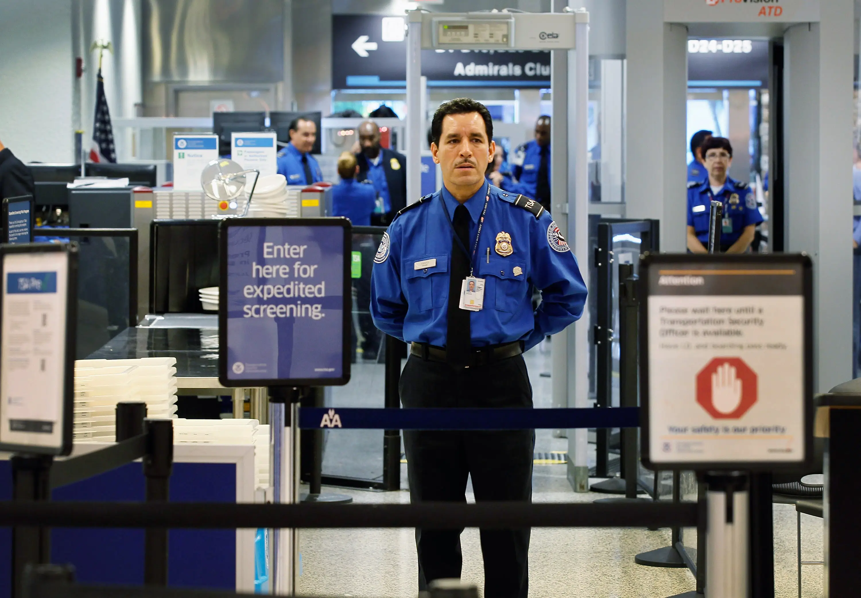 A TSA agent waits for passengers to use the TSA PreCheck lane being implemented by the Transportation Security Administration at Miami International Airport on October 4, 2011 in Miami, Florida.