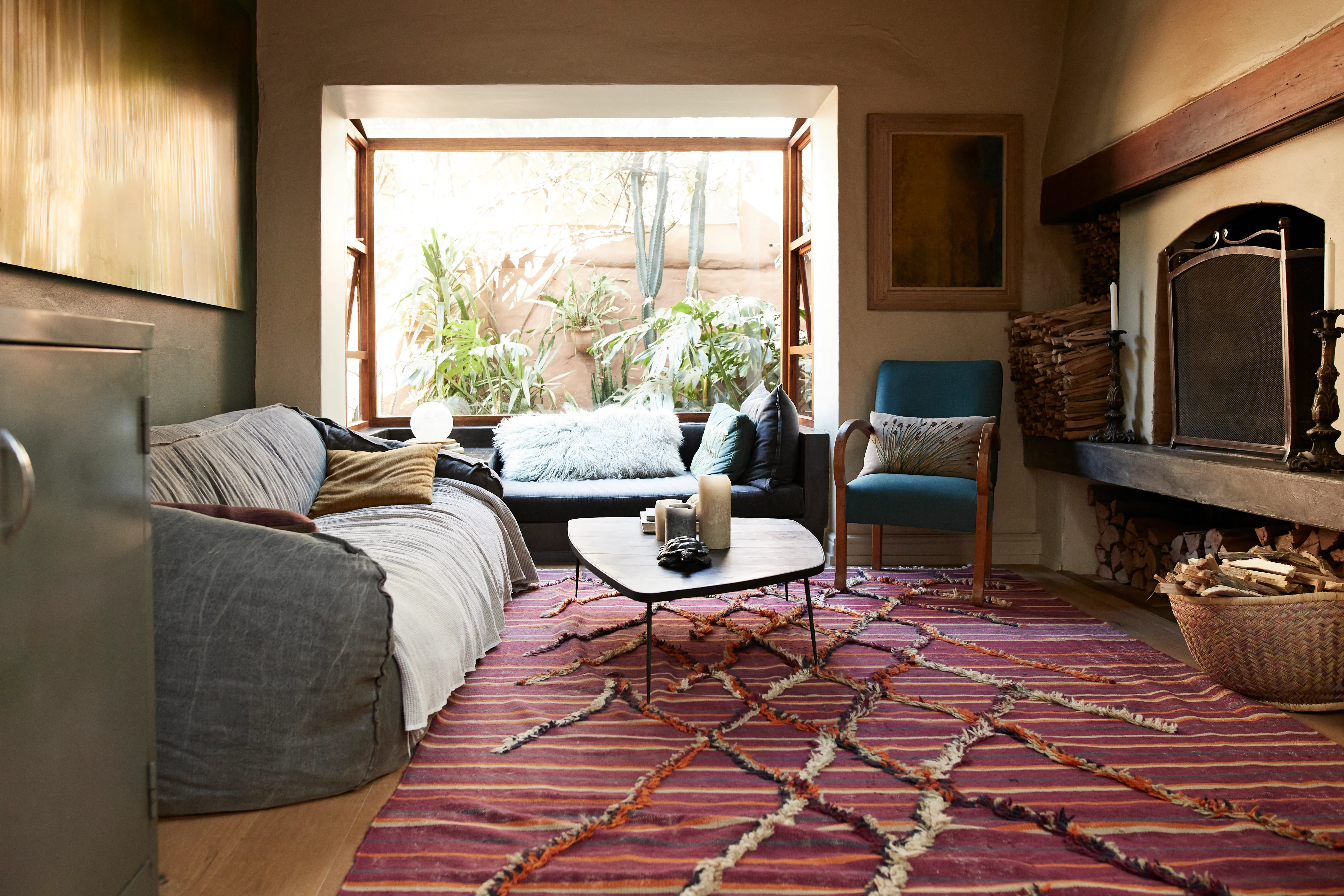 Living room with small red rug, large windows