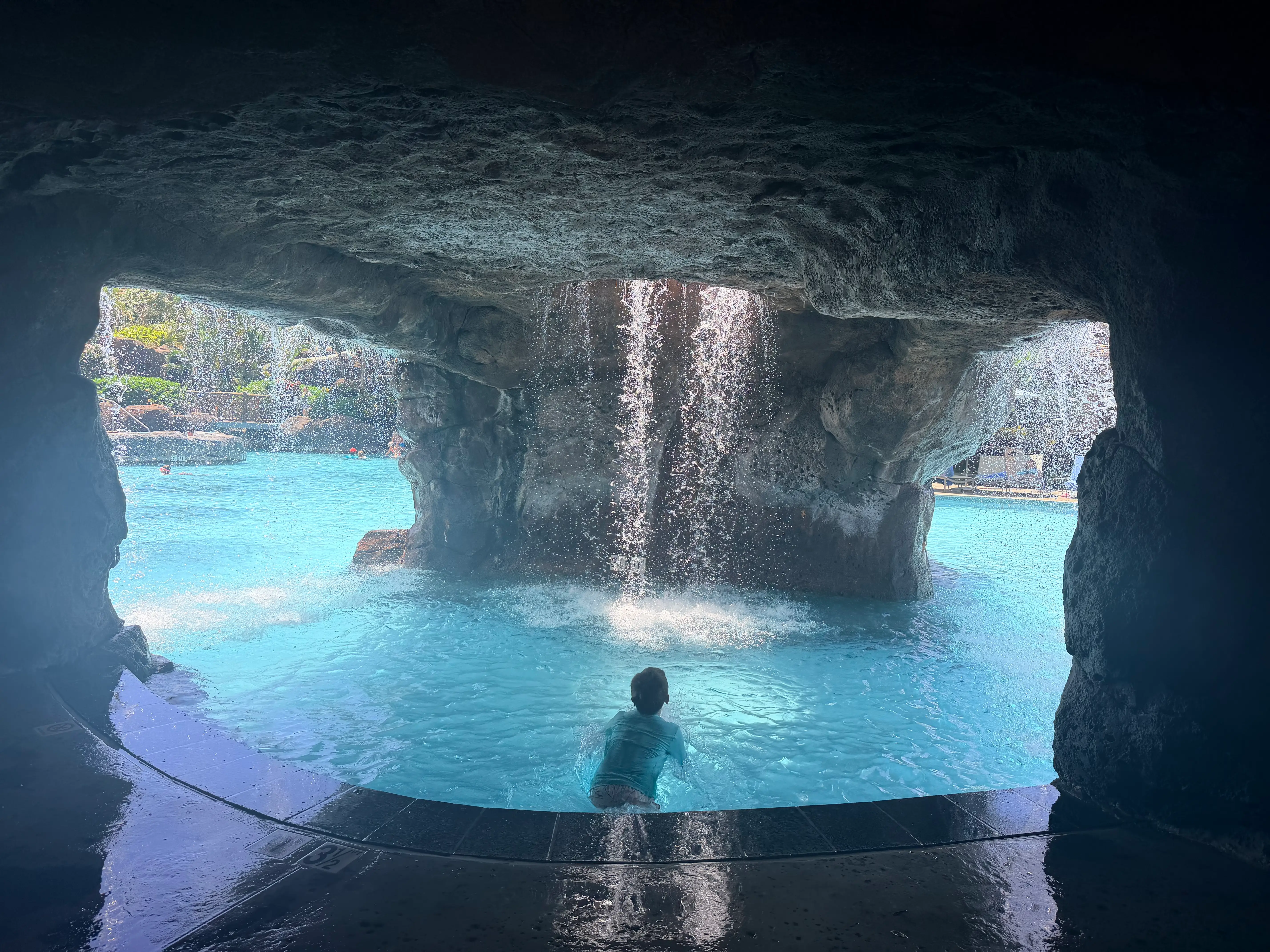 The author's son in a grotto created in a pool with a waterfall