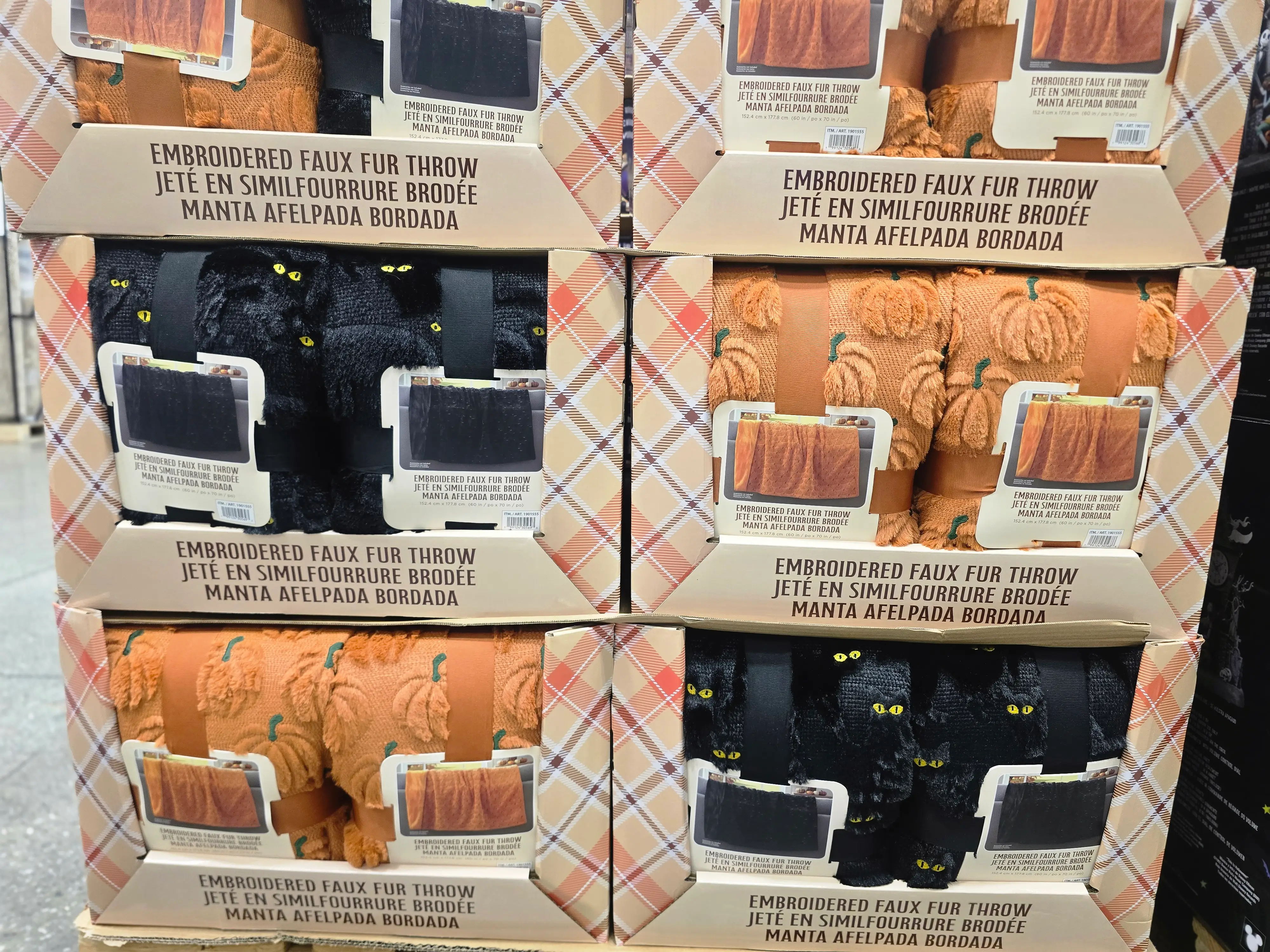 Embroidered Halloween-themed throw blankets in orange and black colorways.