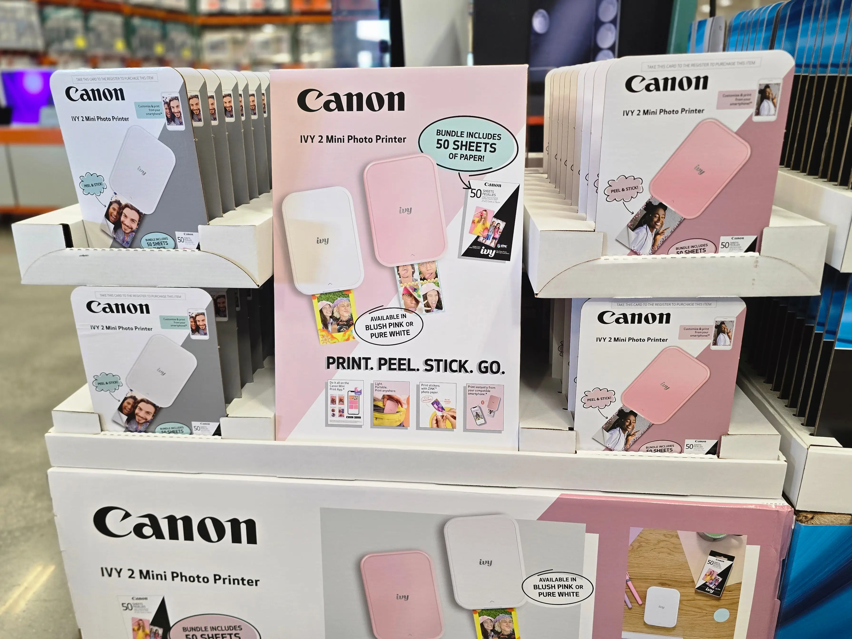Boxes of Canon Ivy 2 mini photo printers on display at Costco.