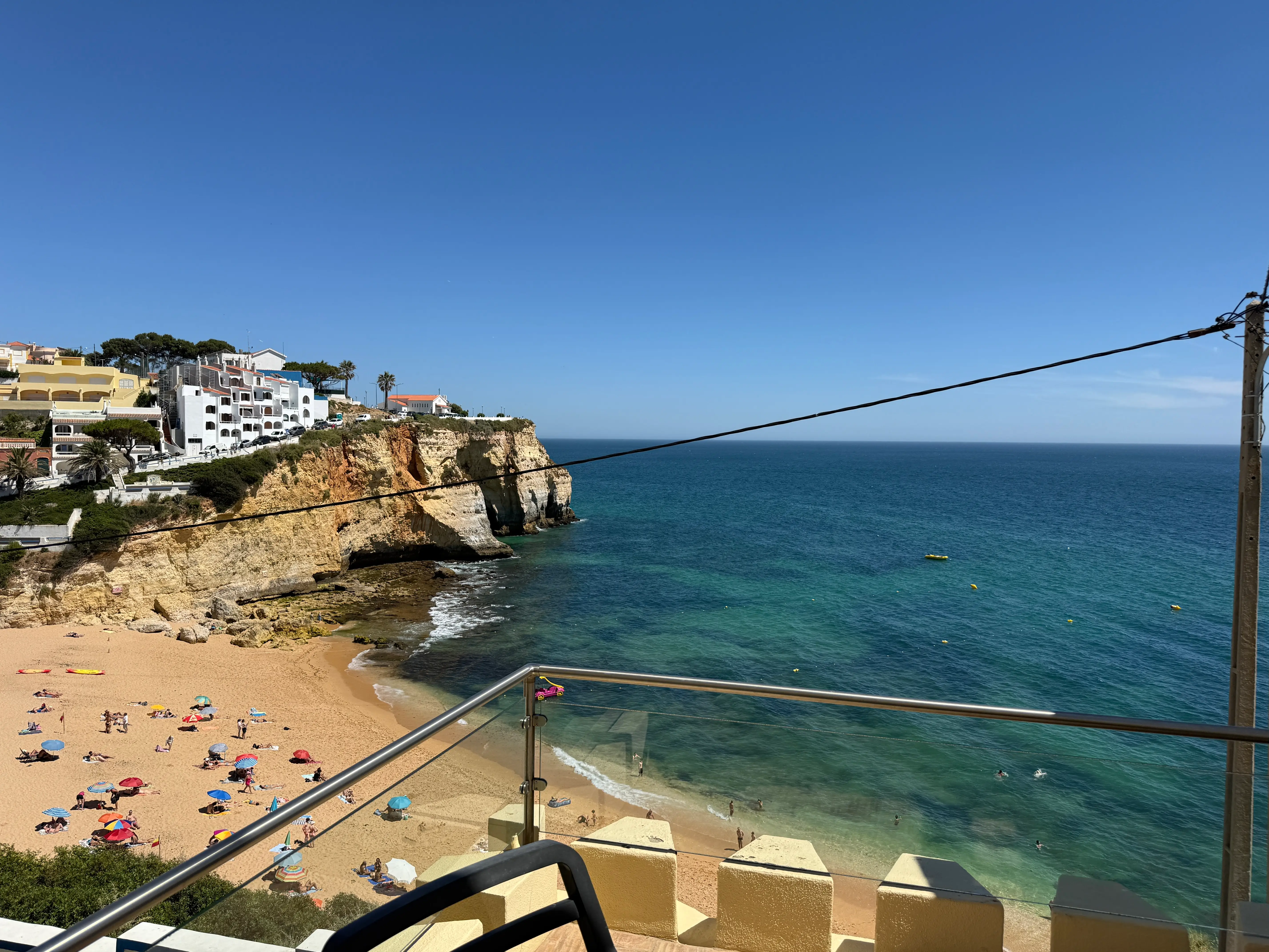 View of water and sand from glass balcony