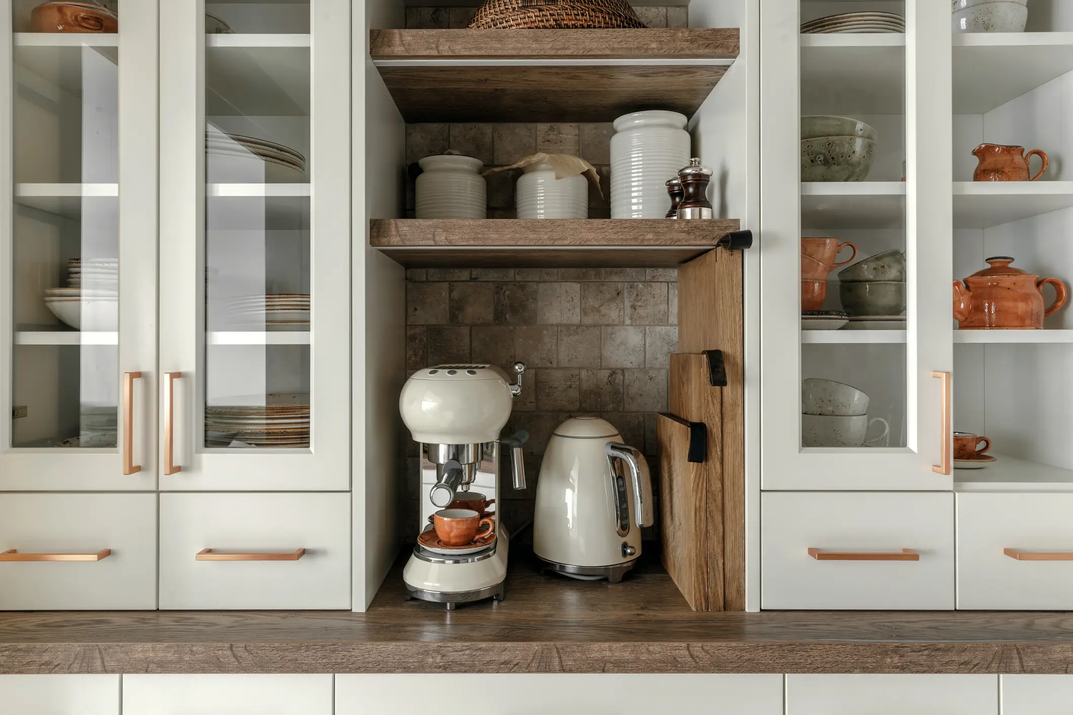 Built-in coffee bar area next to white cabinets
