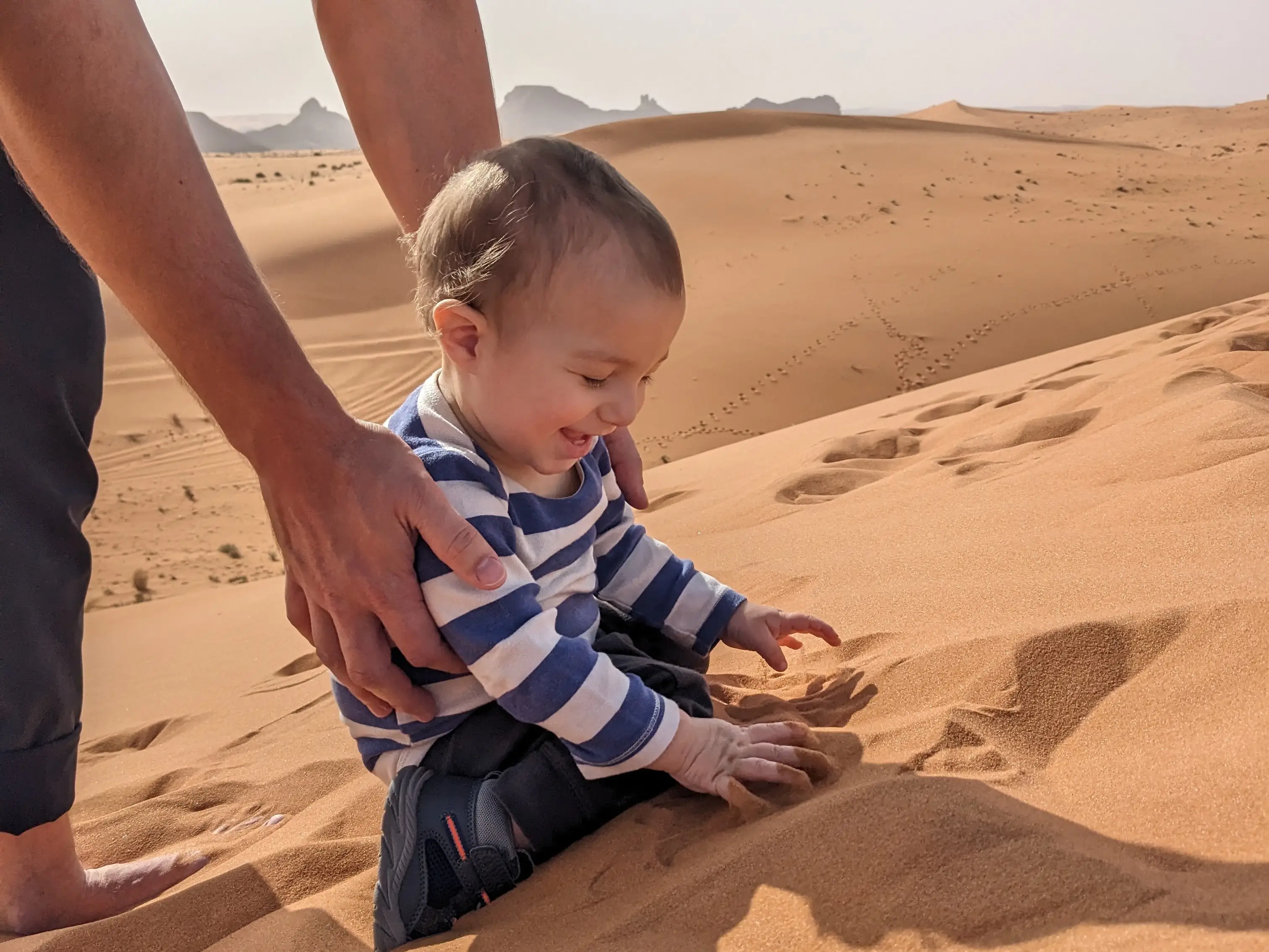 The author's son playing in a sand dune in Saudi Arabia.