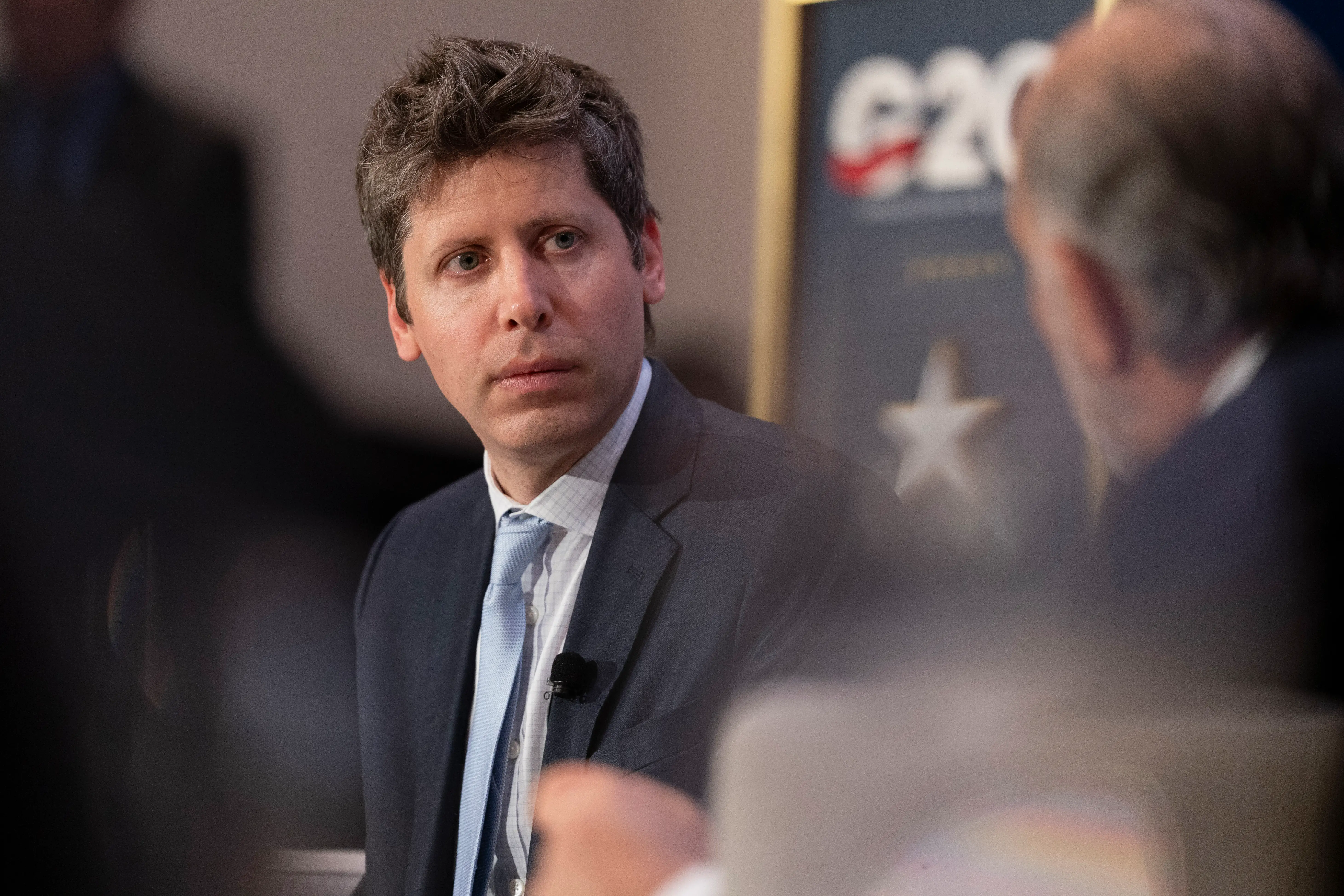 Sam Altman talks on stage during the G20 conference.