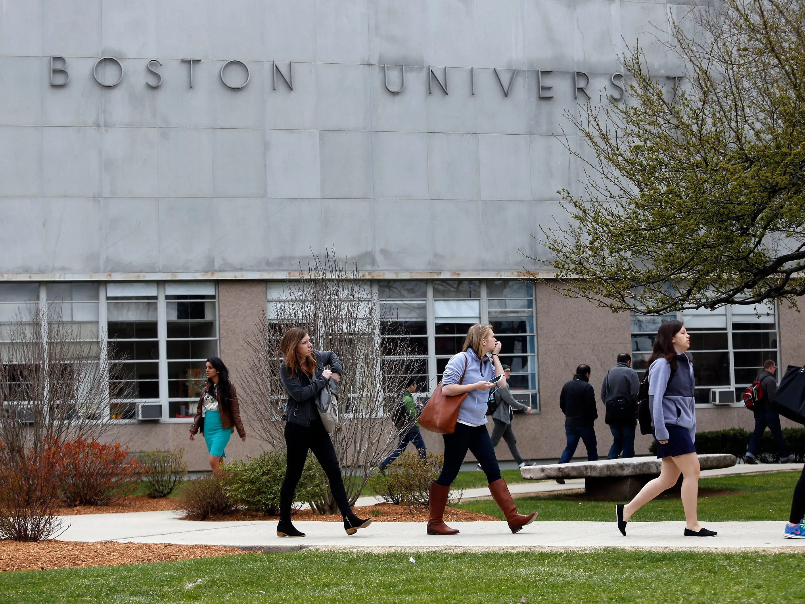 Students walk on a college campus.