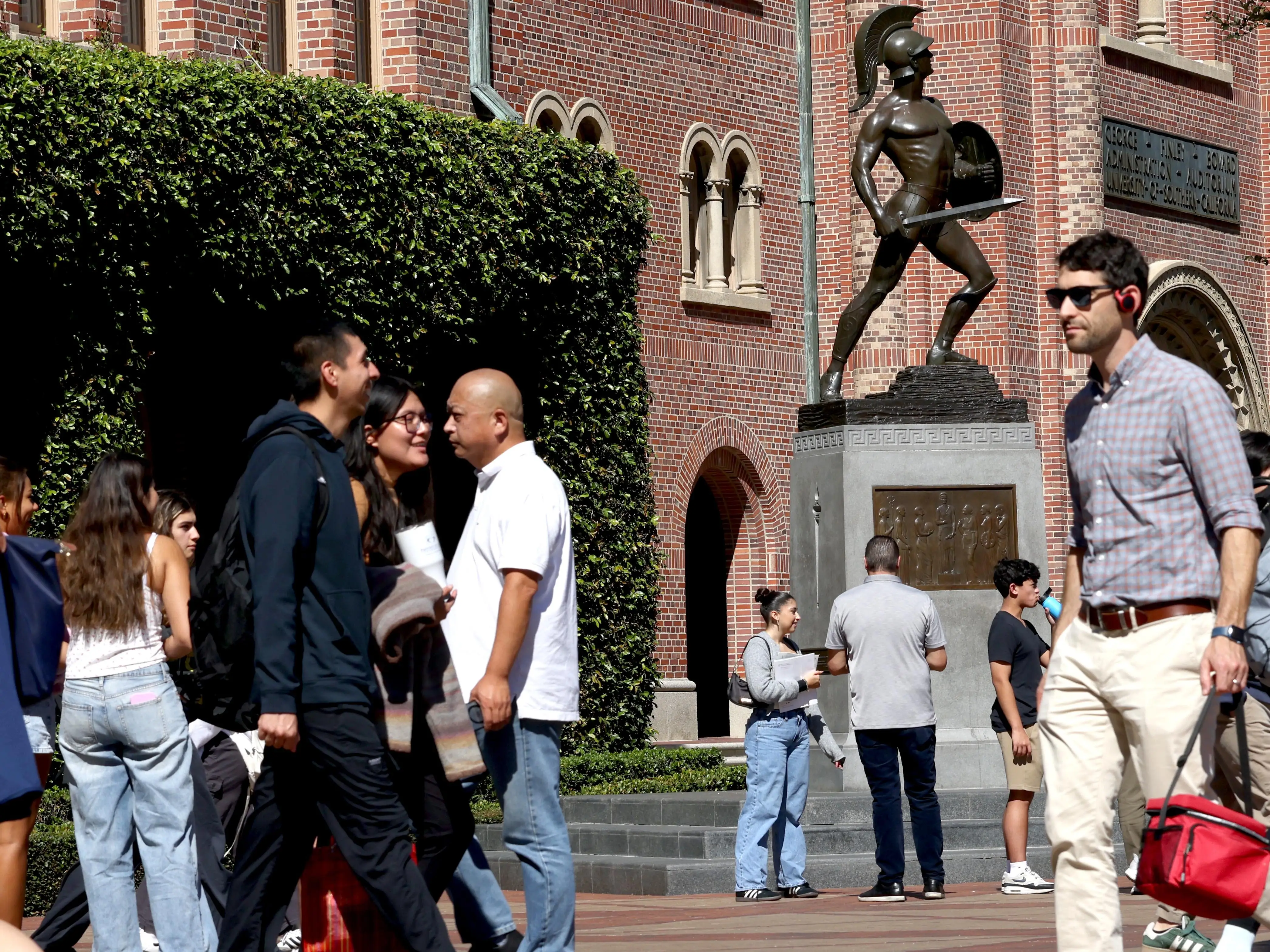 Students walk on a college campus.