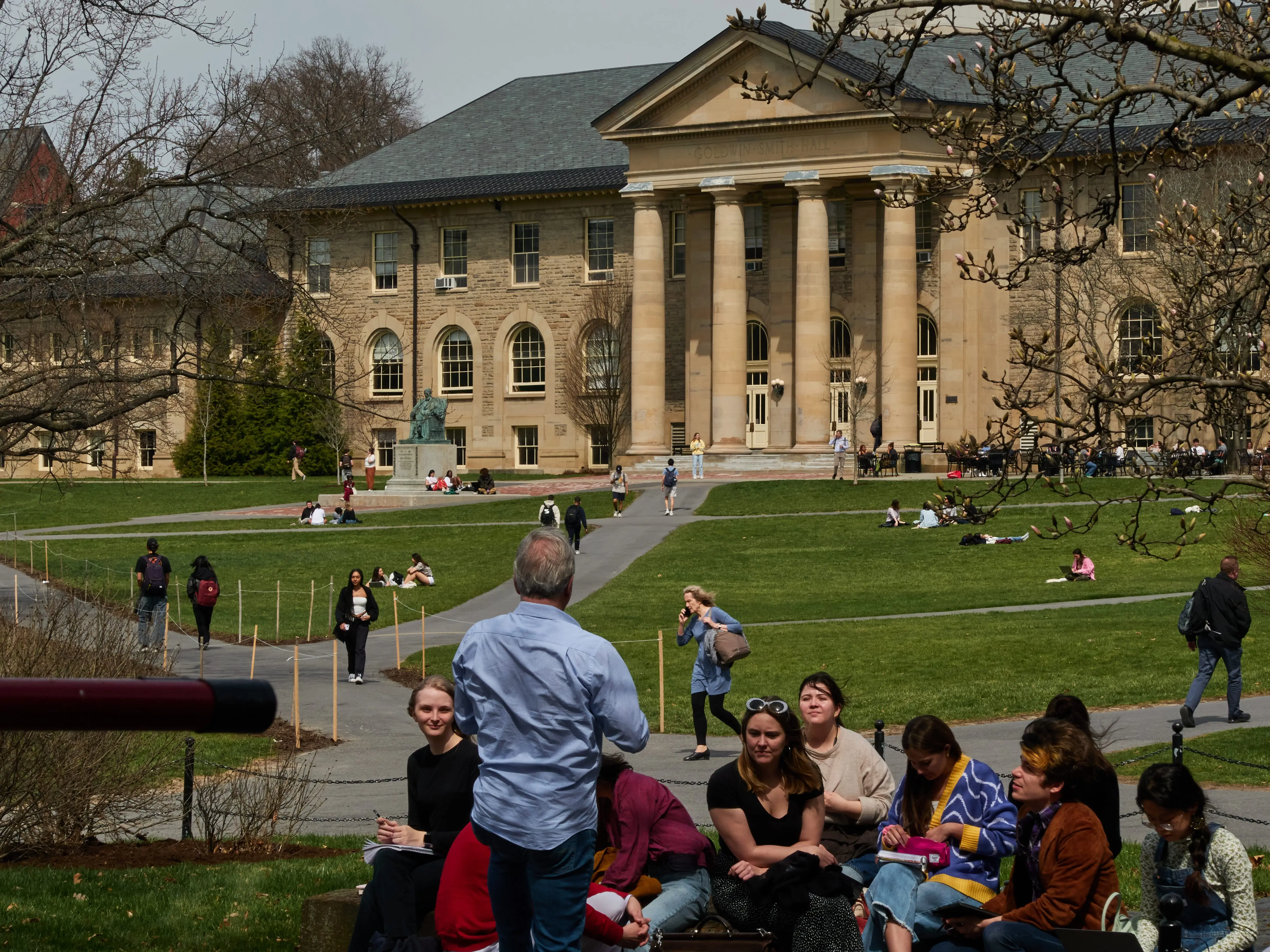 Students walk on a college campus.