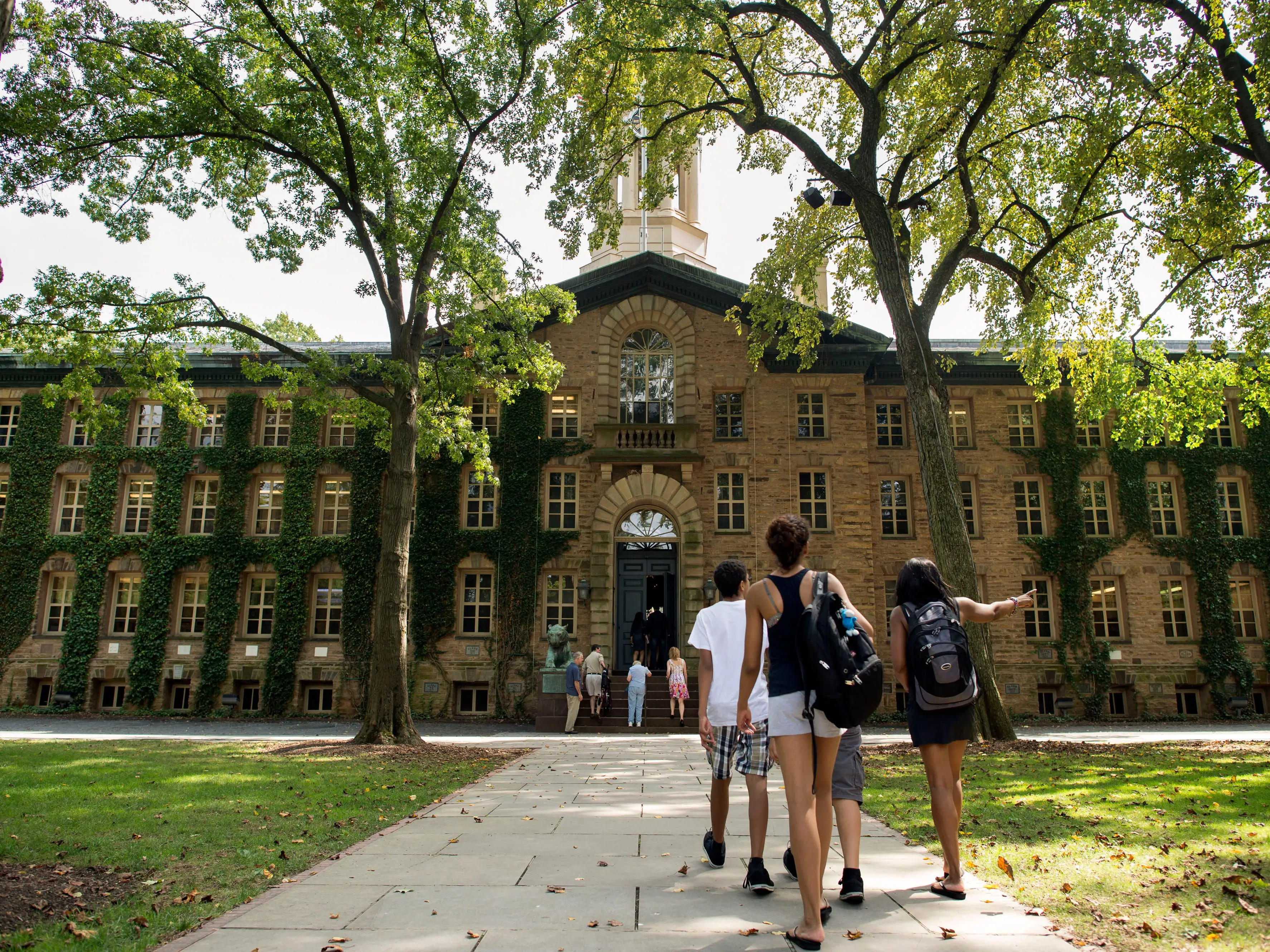Students walk on a college campus.