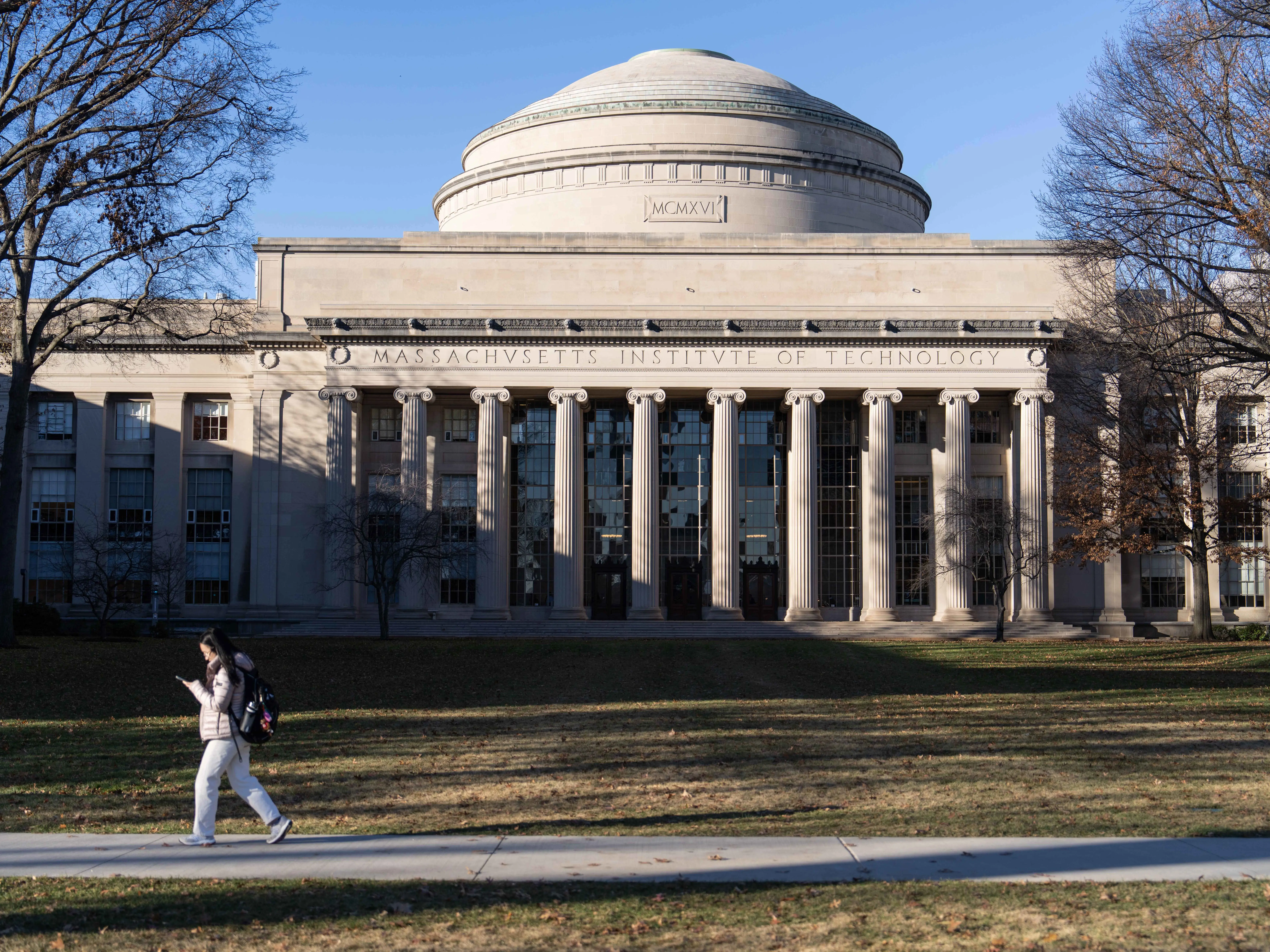 A student walks on a college campus.