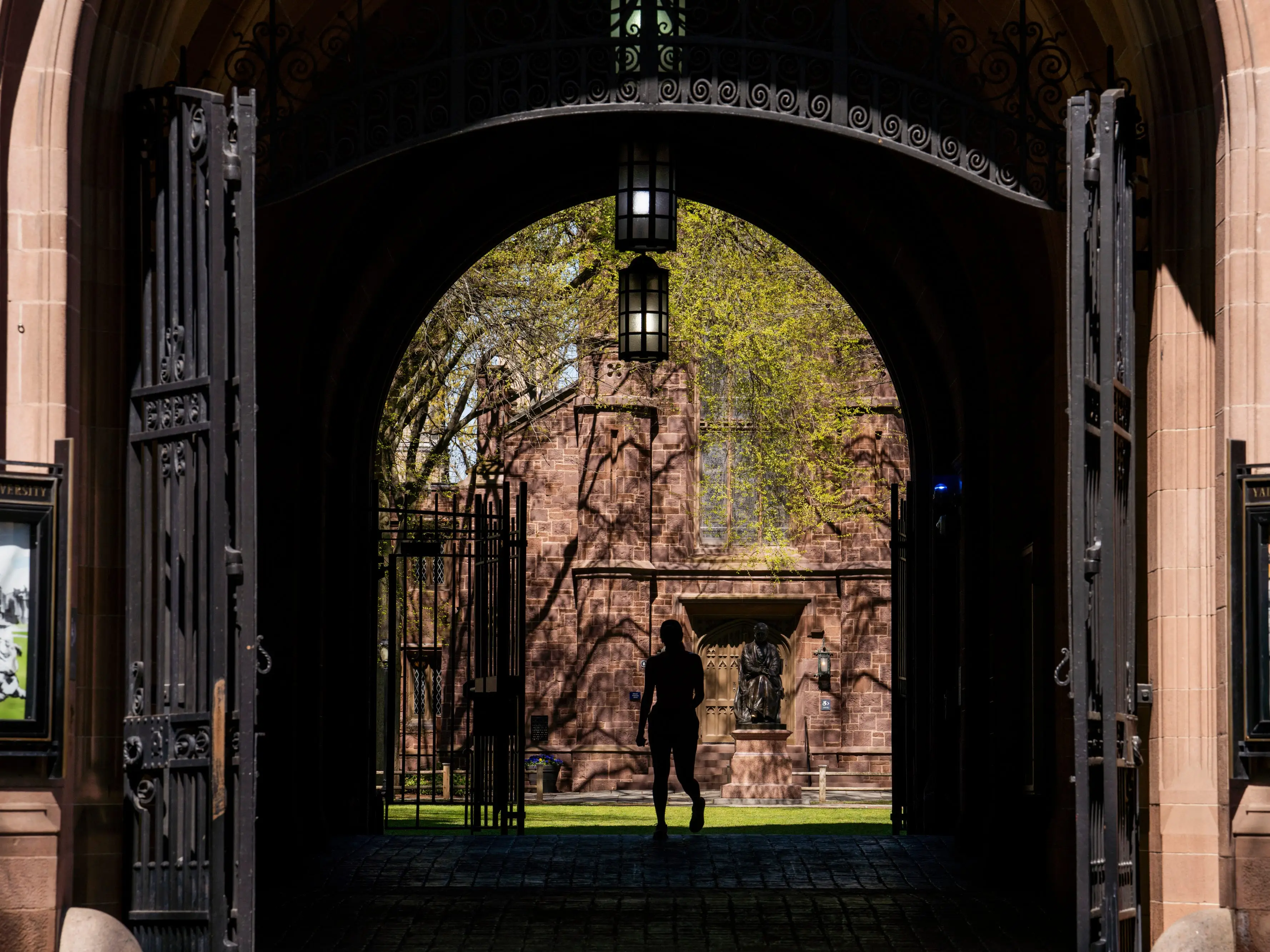 A student walks through a college campus.
