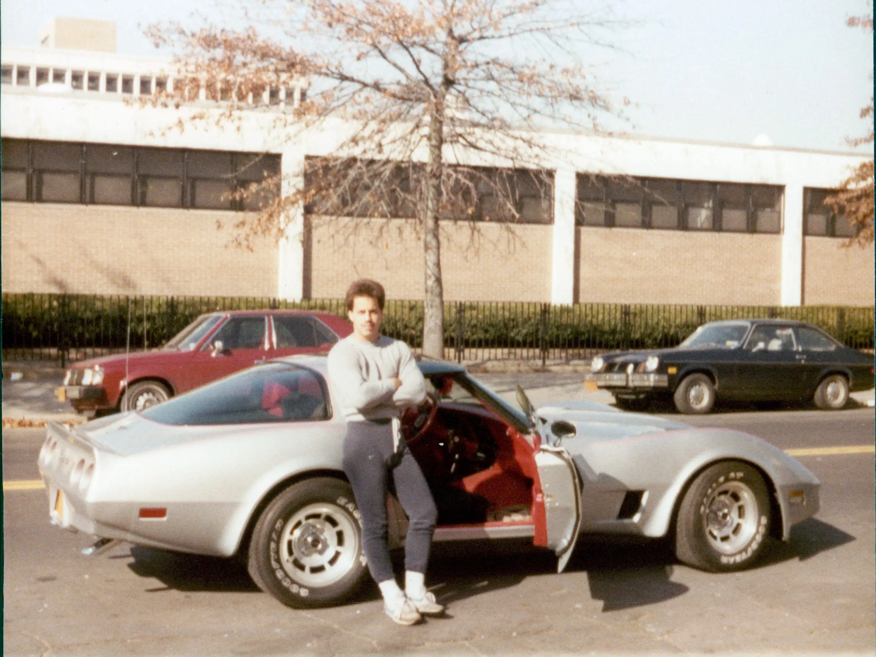 Man posing with Corvette