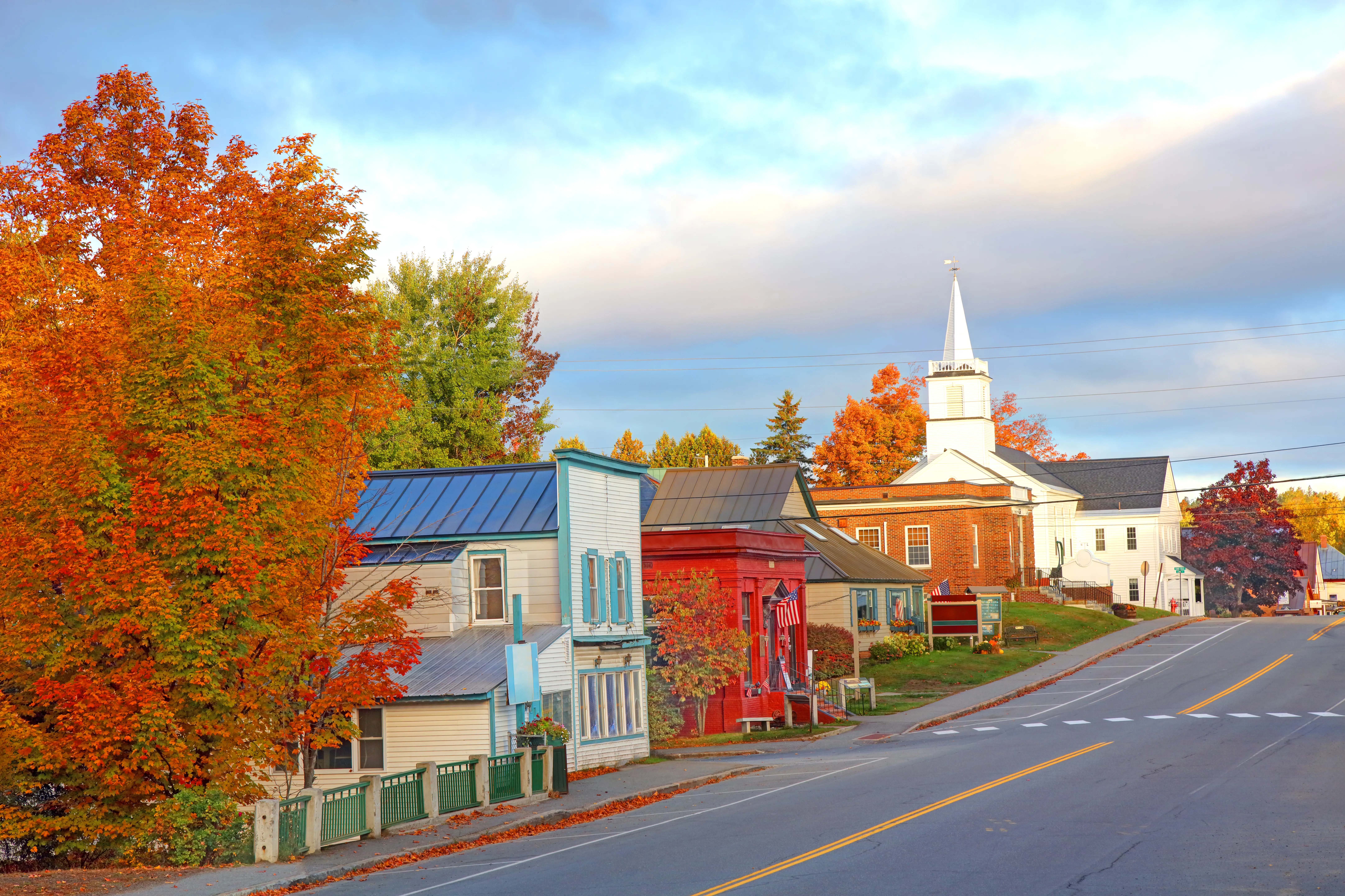 A street in Rangeley, Maine, with small houses and orange trees.