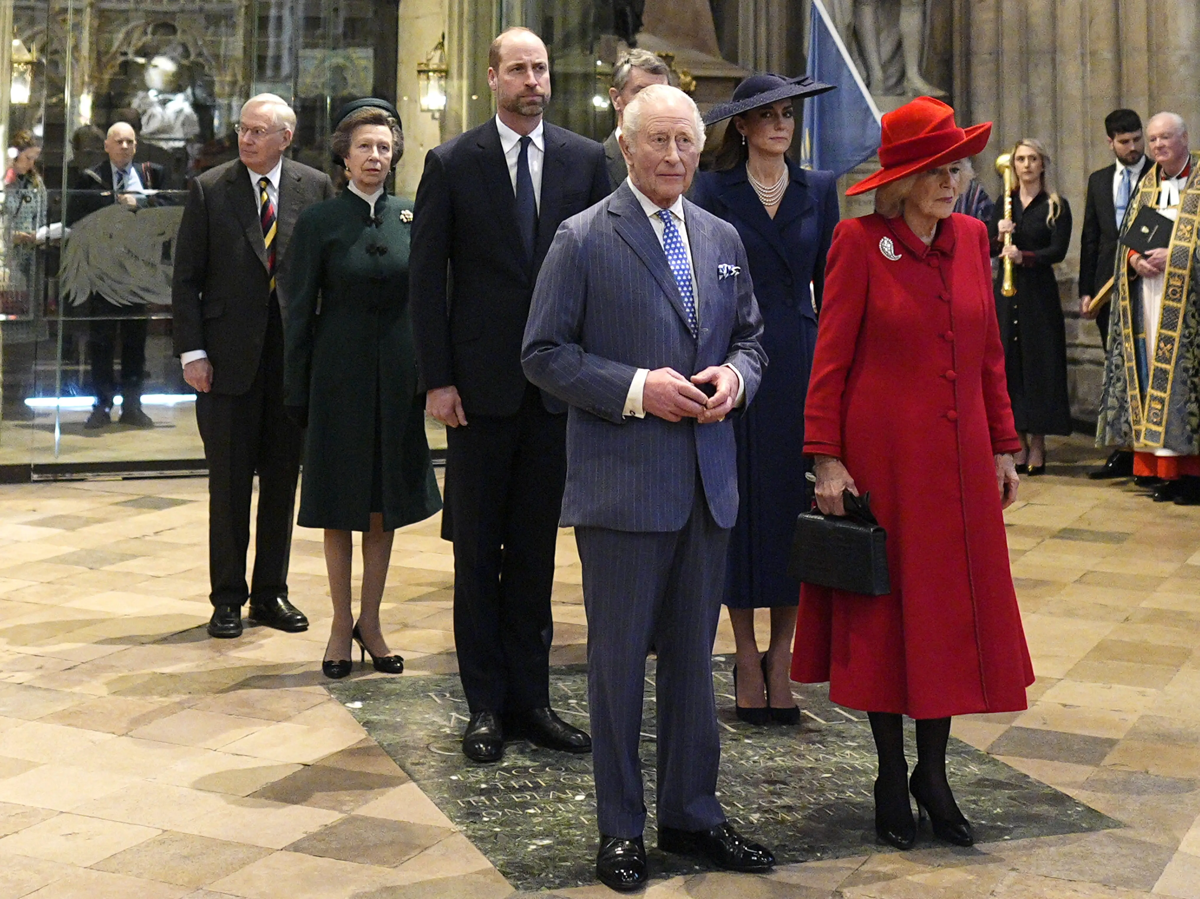 King Charles III and Queen Camilla stand with royal family members and clergy inside Westminster Abbey.