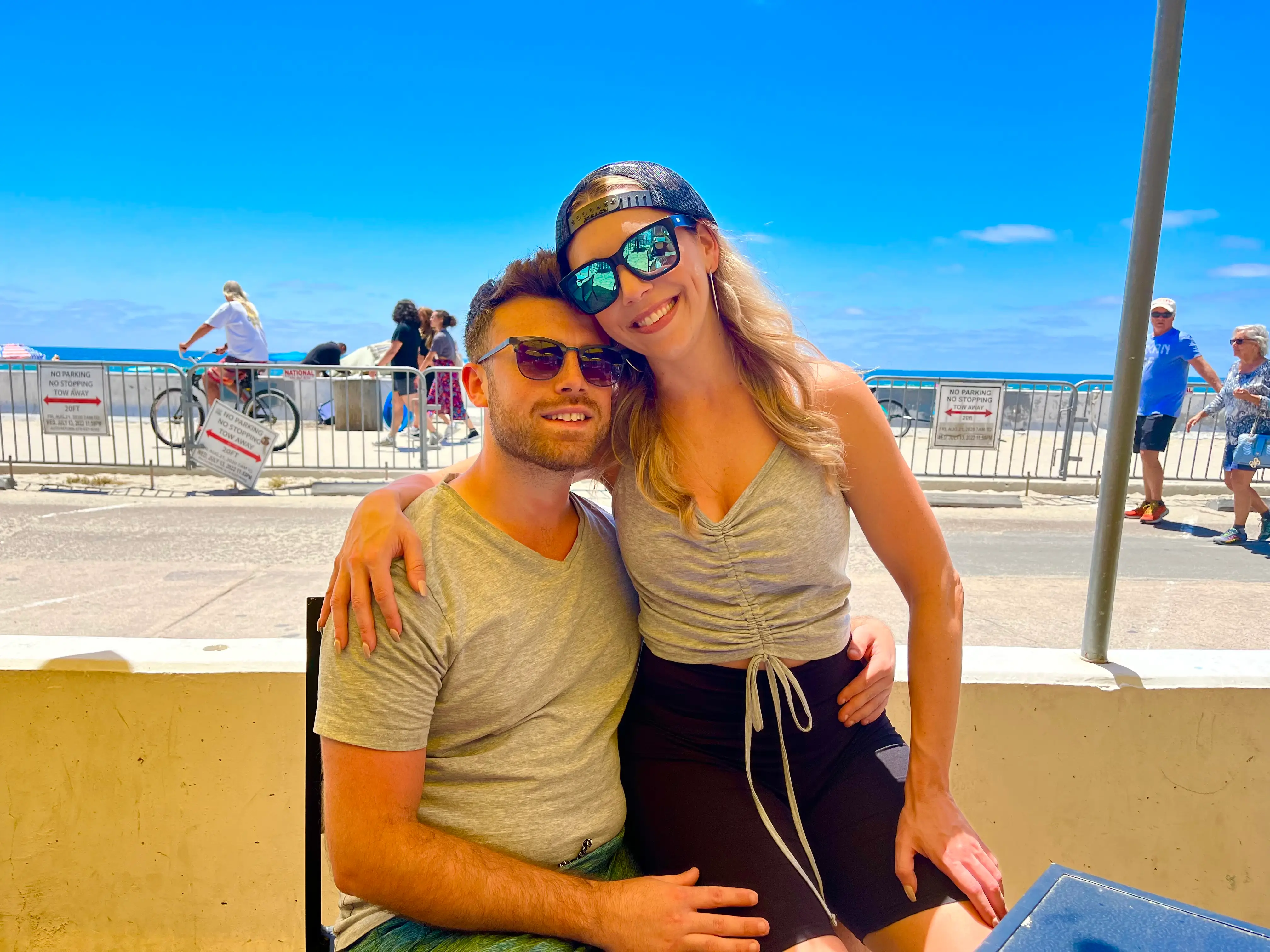 the author and her husband sitting outside on a boardwalk
