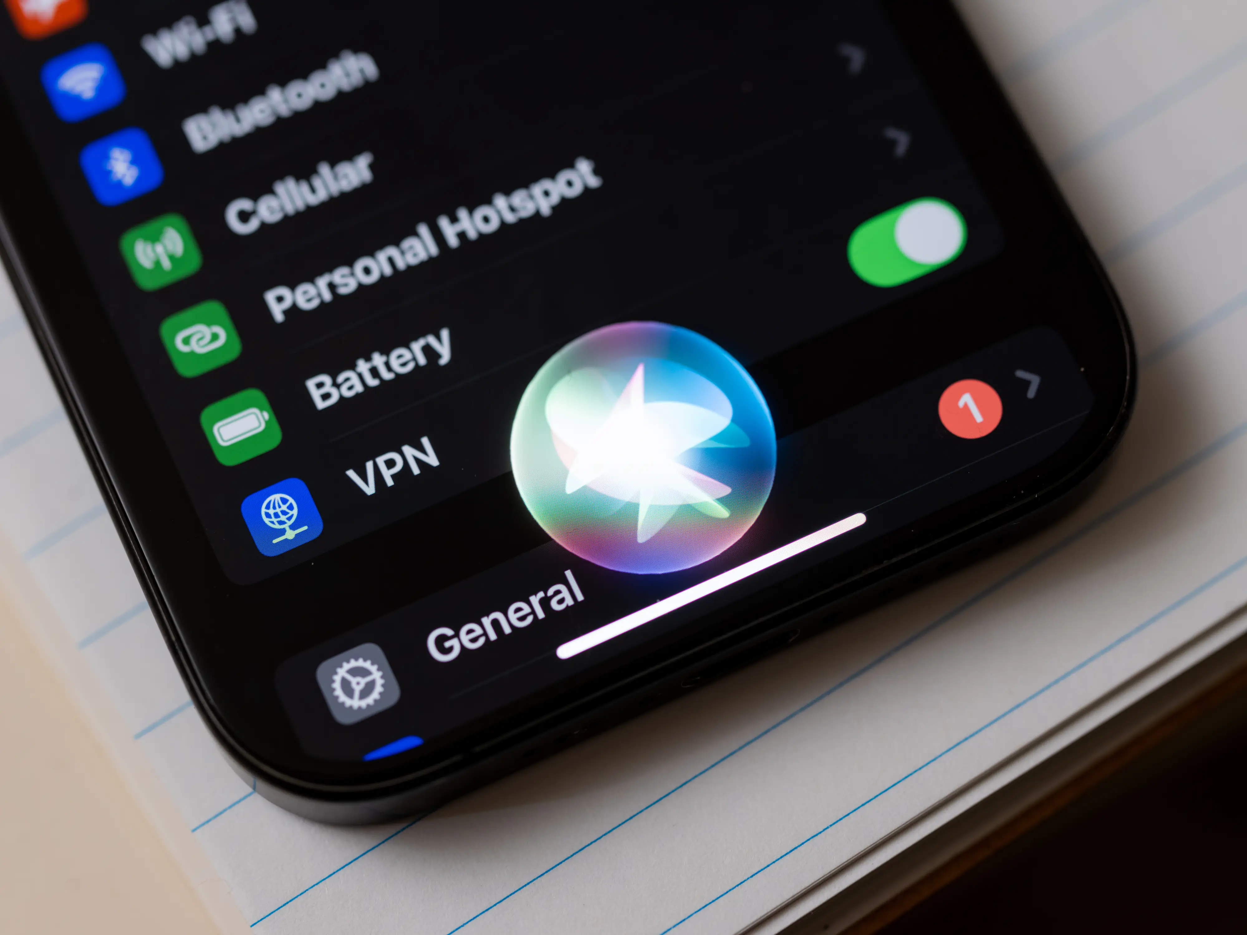 An iPhone with the Siri bubble active.