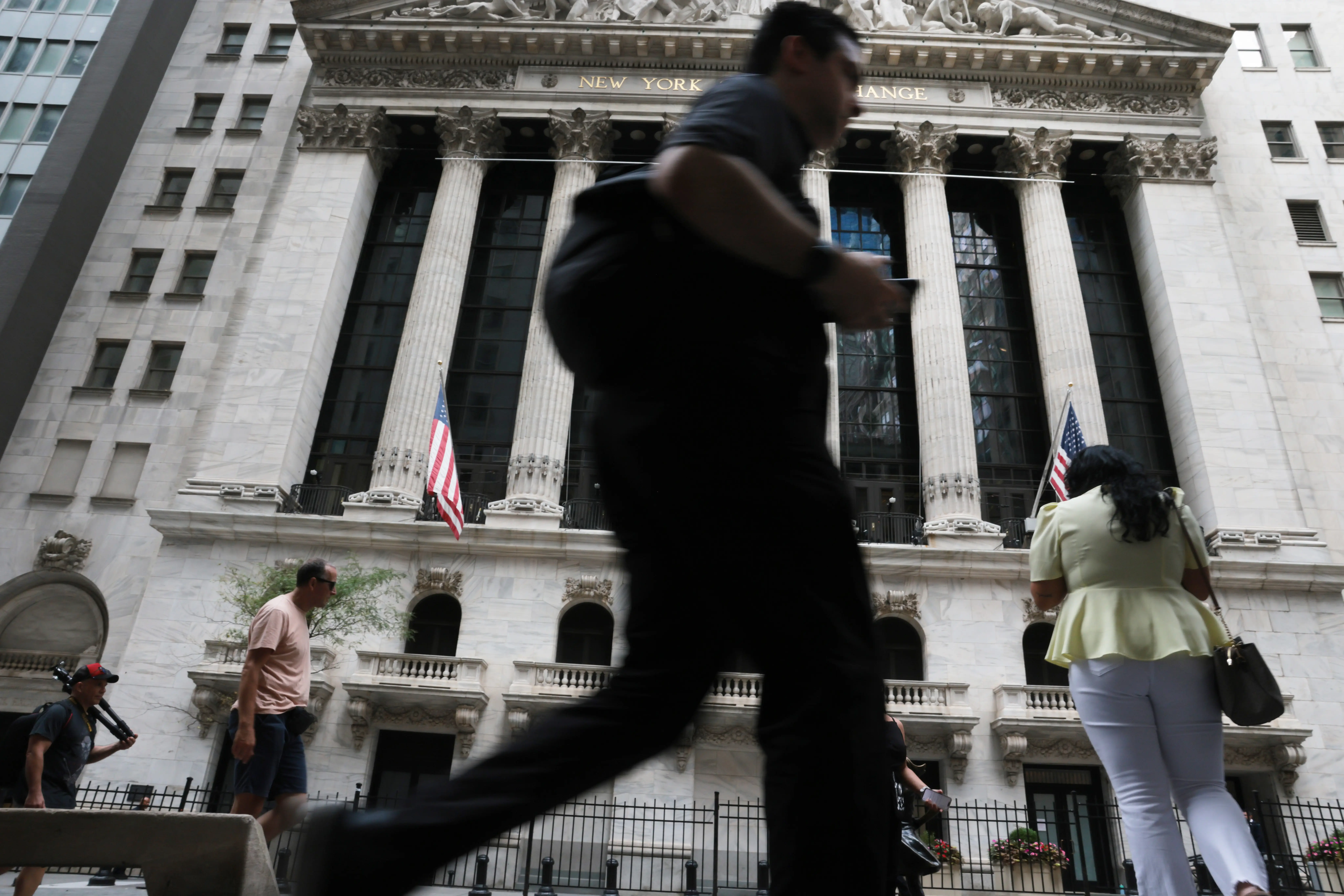 A person walks down wall street