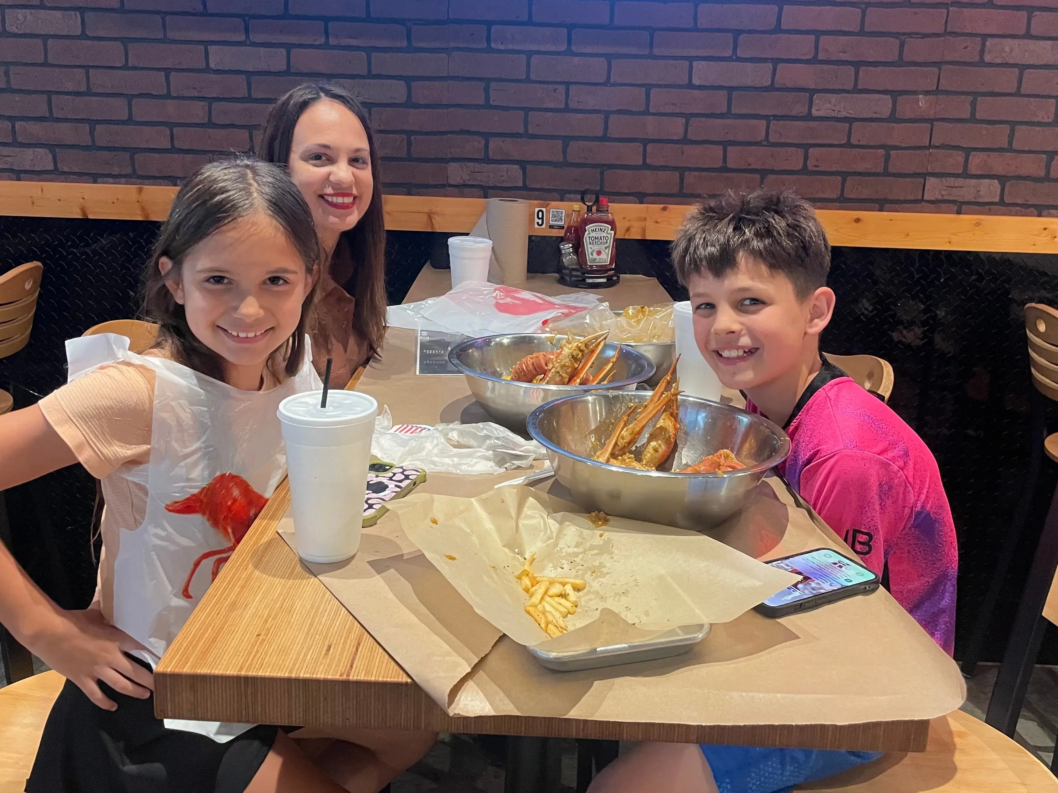 The author and her kids enjoy eating crab legs while out to dinner.