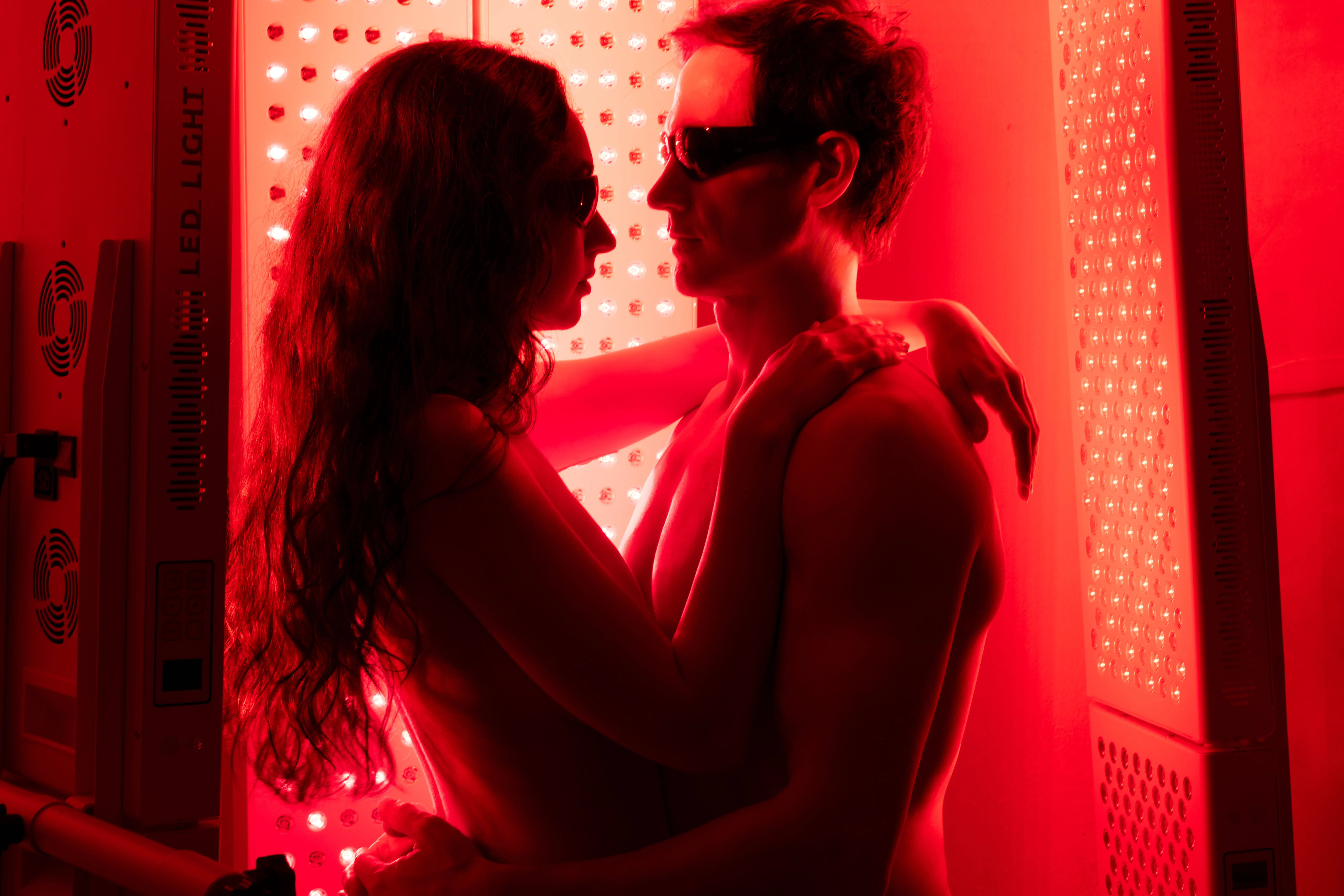 Kate Tolo and Bryan Johnson under the light of a red light therapy machine