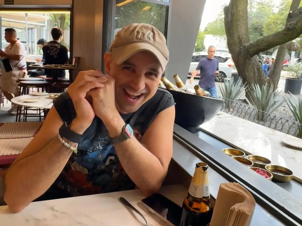 Santiago Barraza Lopez miling and laughing while sitting at a table in a restaurant