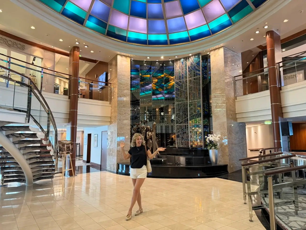 The author on the cruise trip in a grand lobby