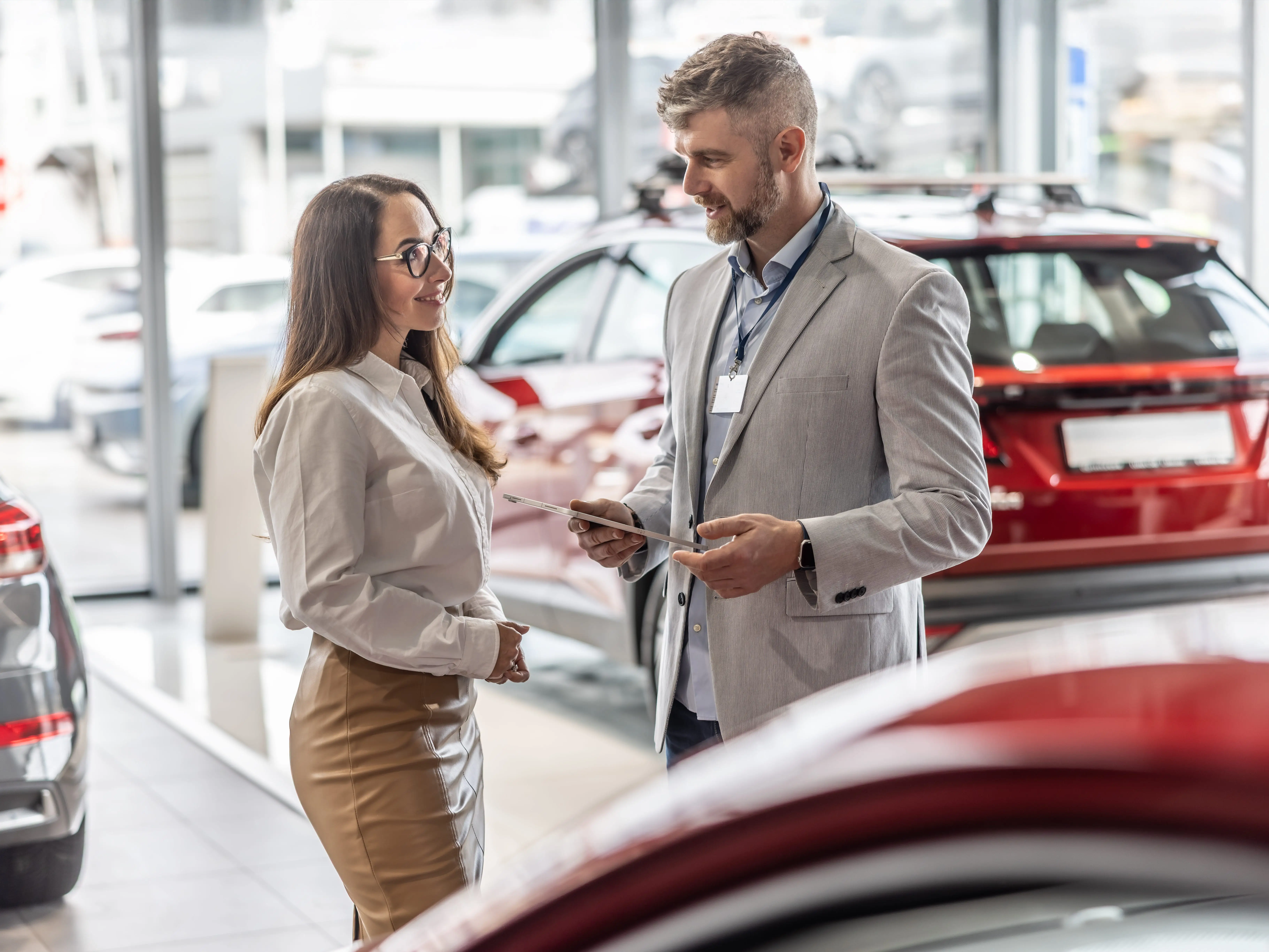 Two people standing in front of car