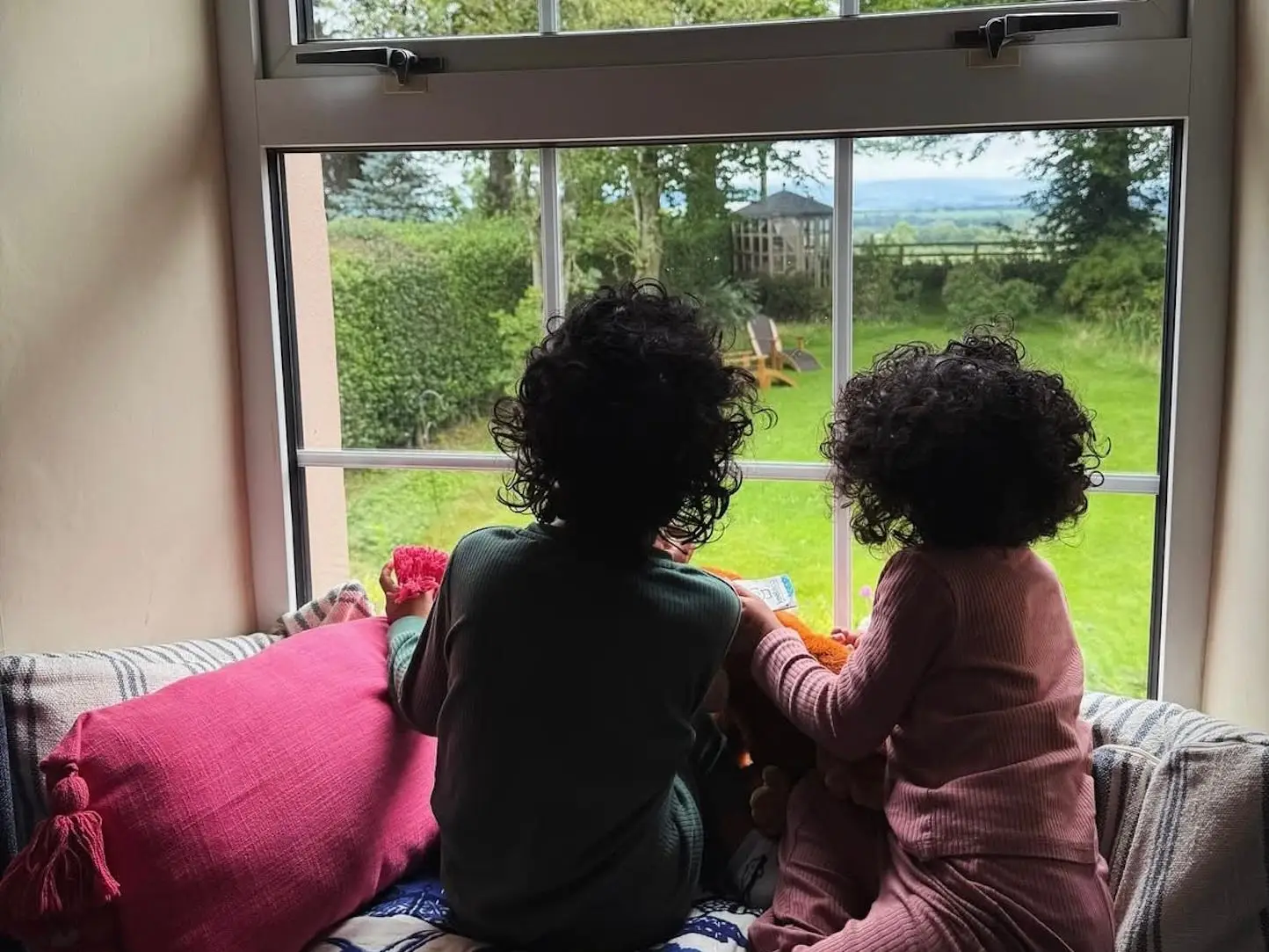 The author's two children look out a window.