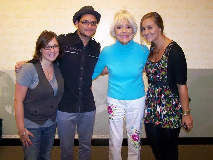 People posing with Carol Channing for a photo
