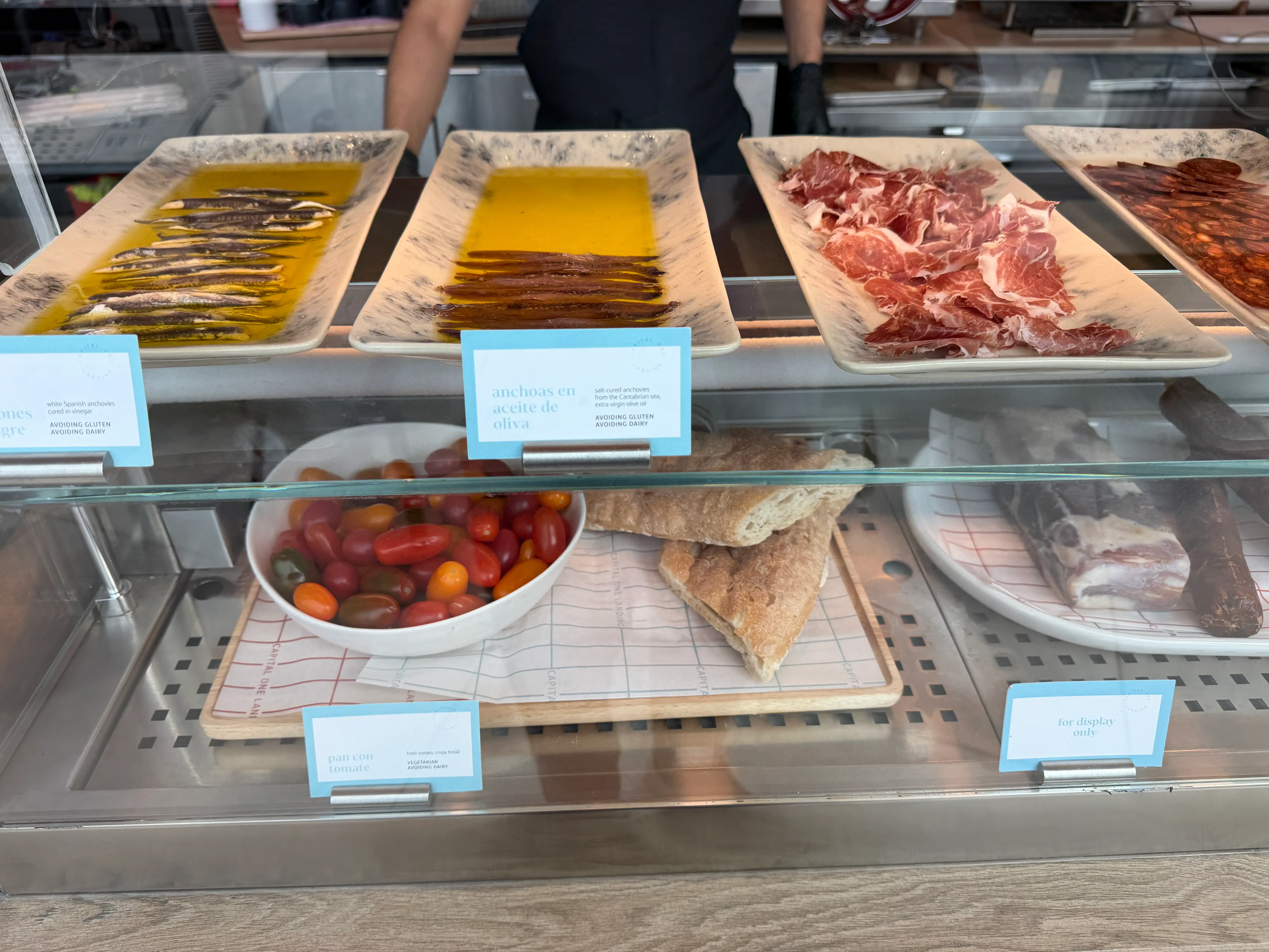 Anchovies, cherry tomatoes, and cured meat at the Capital One Landing