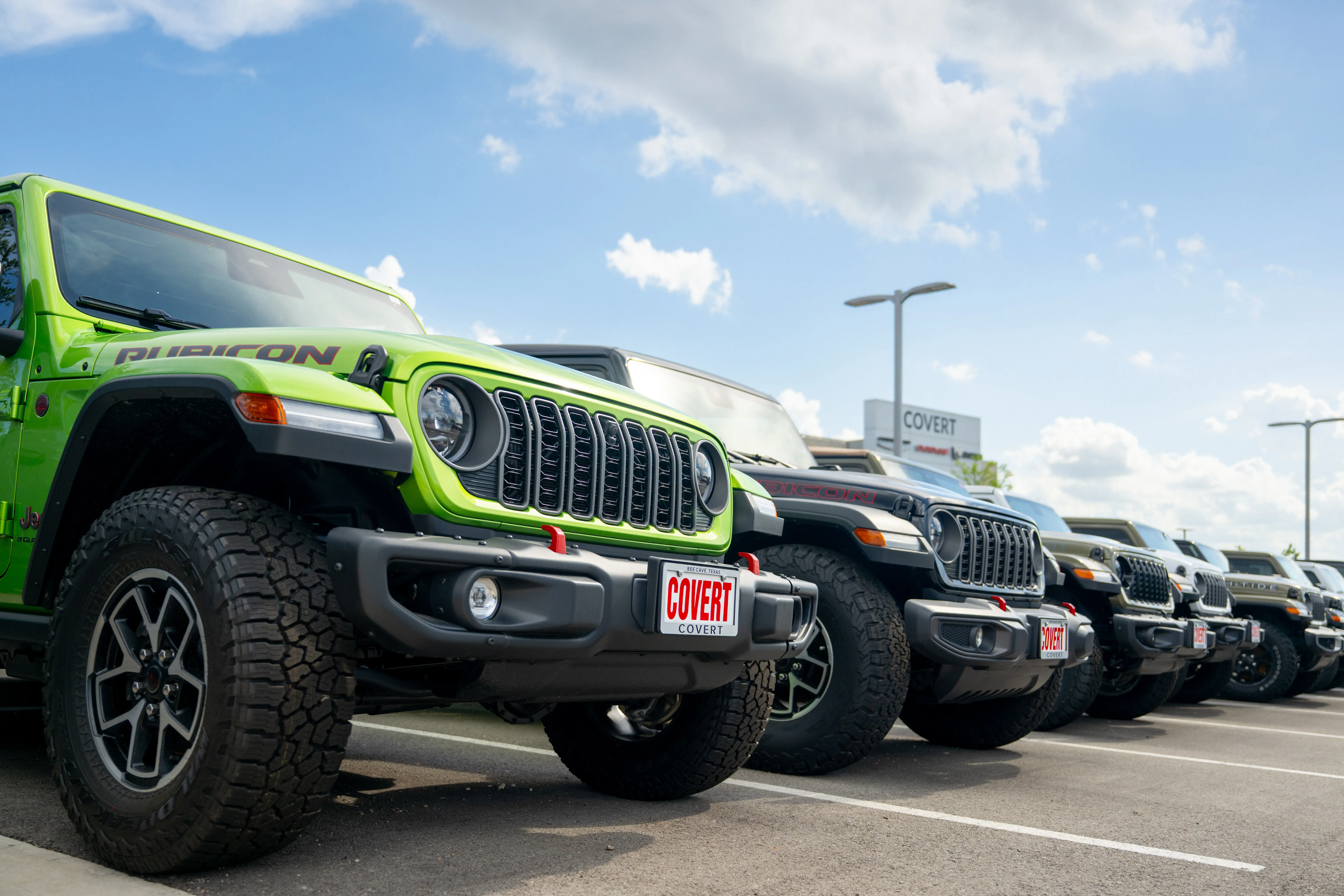A Jeep dealership with a lineup of Wranglers and Gladiators.