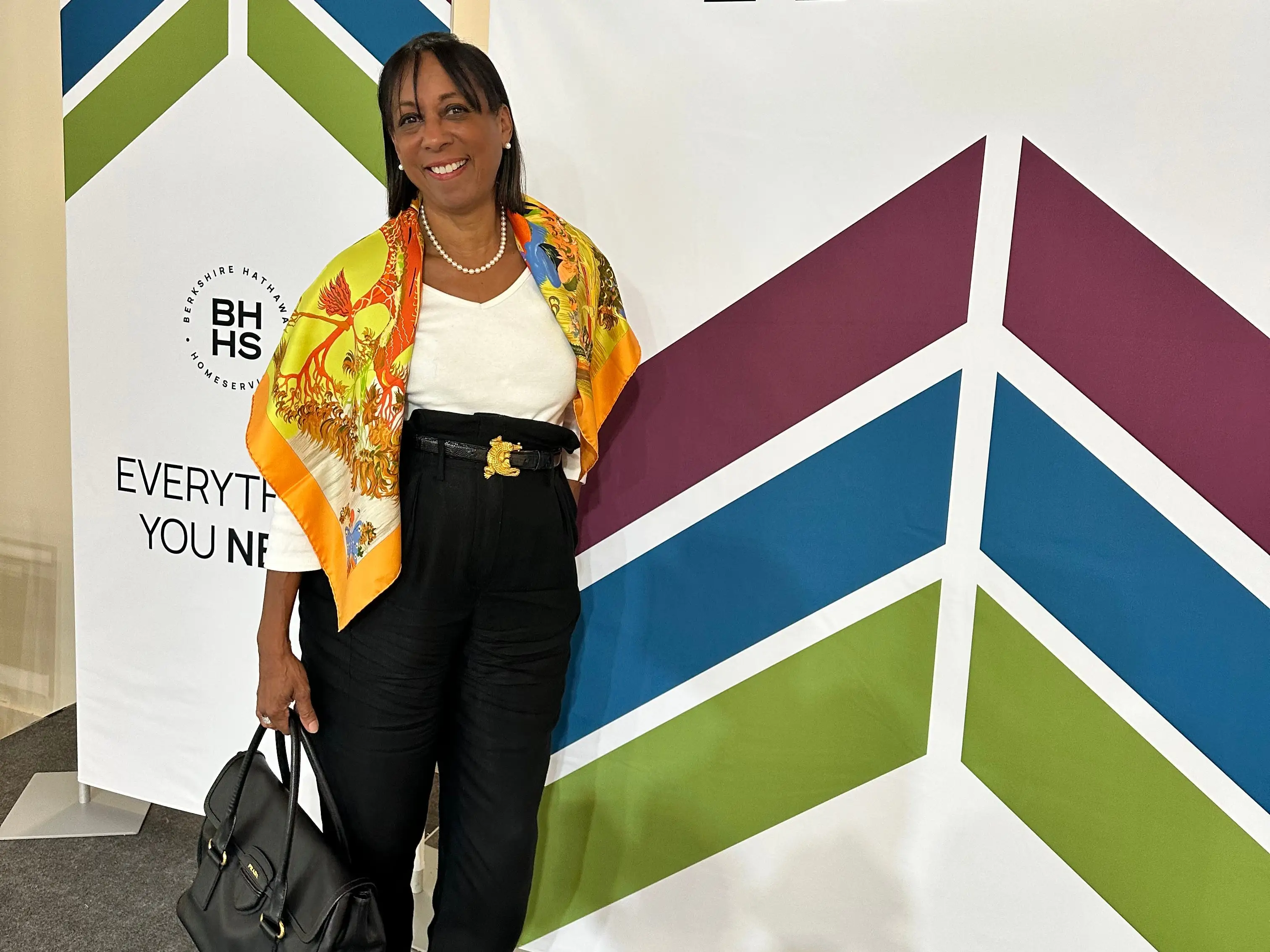 A woman standing next to a display board.