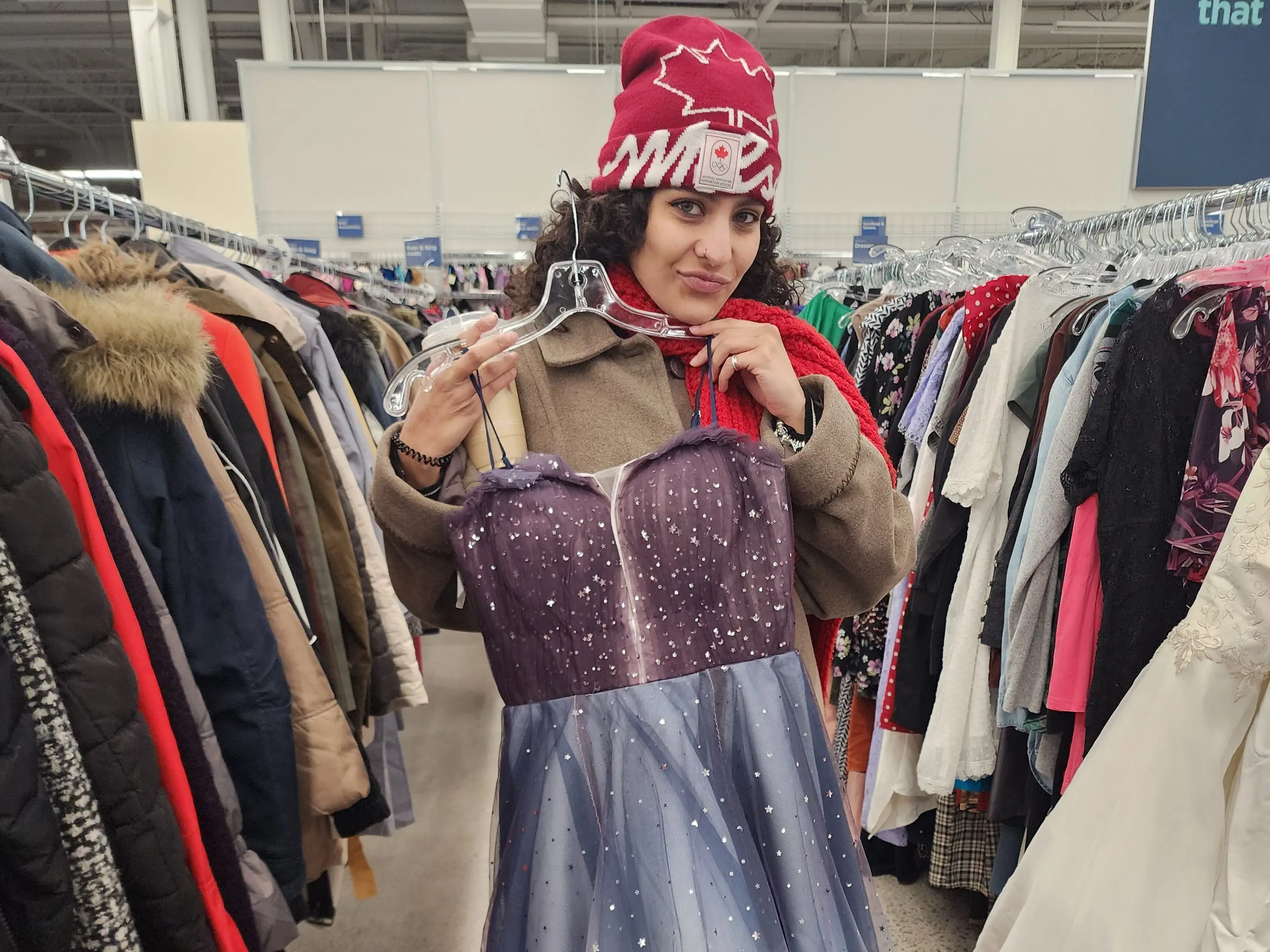 Woman trying on dress at thrift store