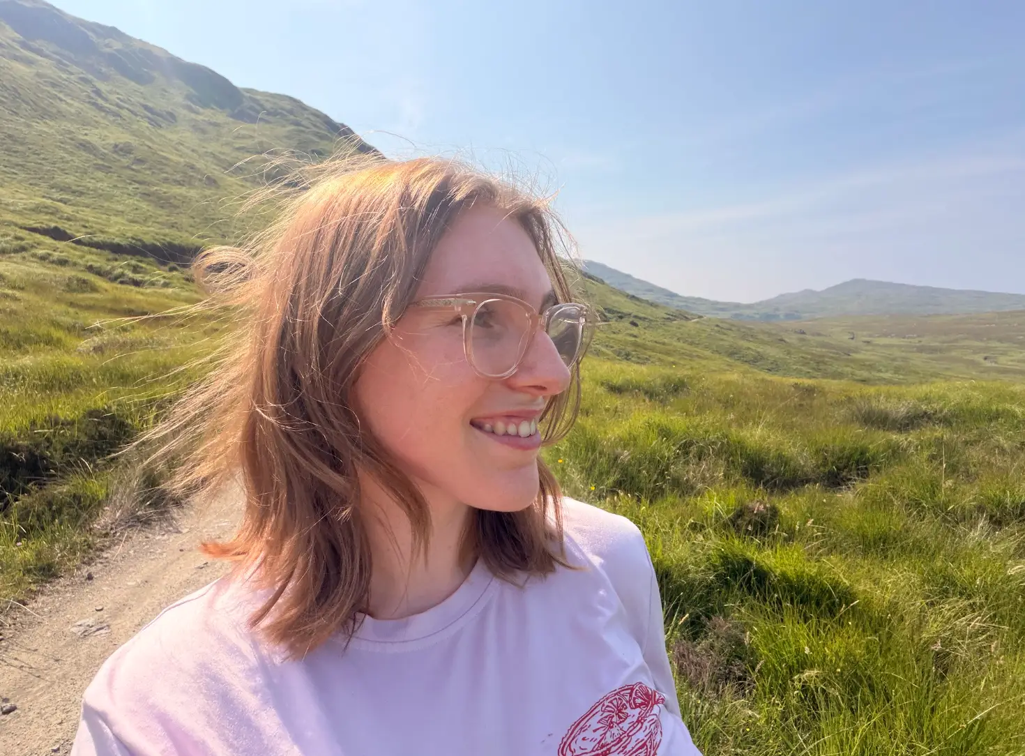 A close-up shot of the writer gazing out at the sky while standing at the Isle of Rum nature preserve.