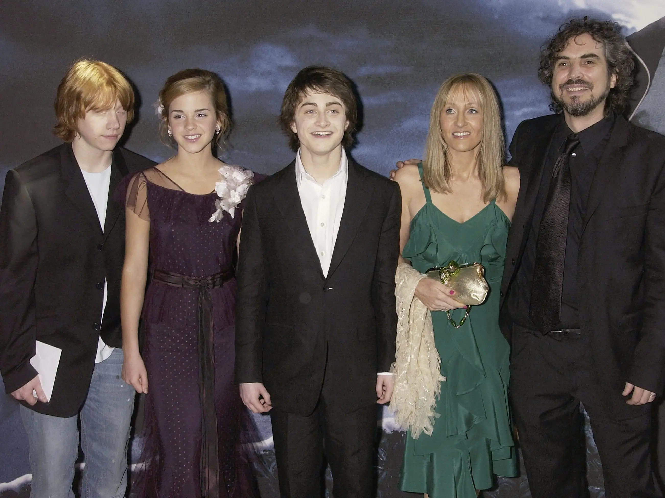 Five people in dress attire pose for a photo.