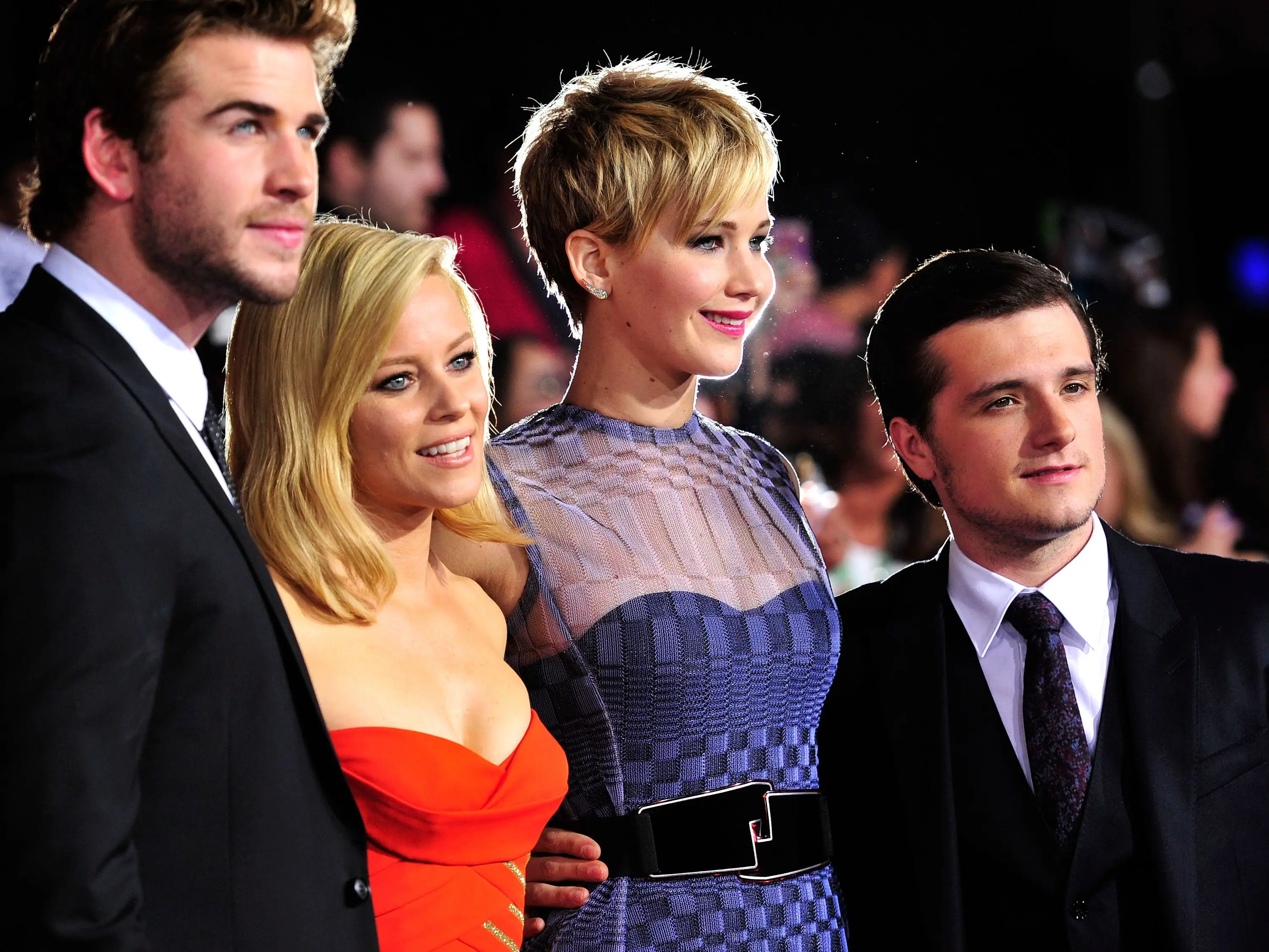 Four people in dress attire pose for a photo.
