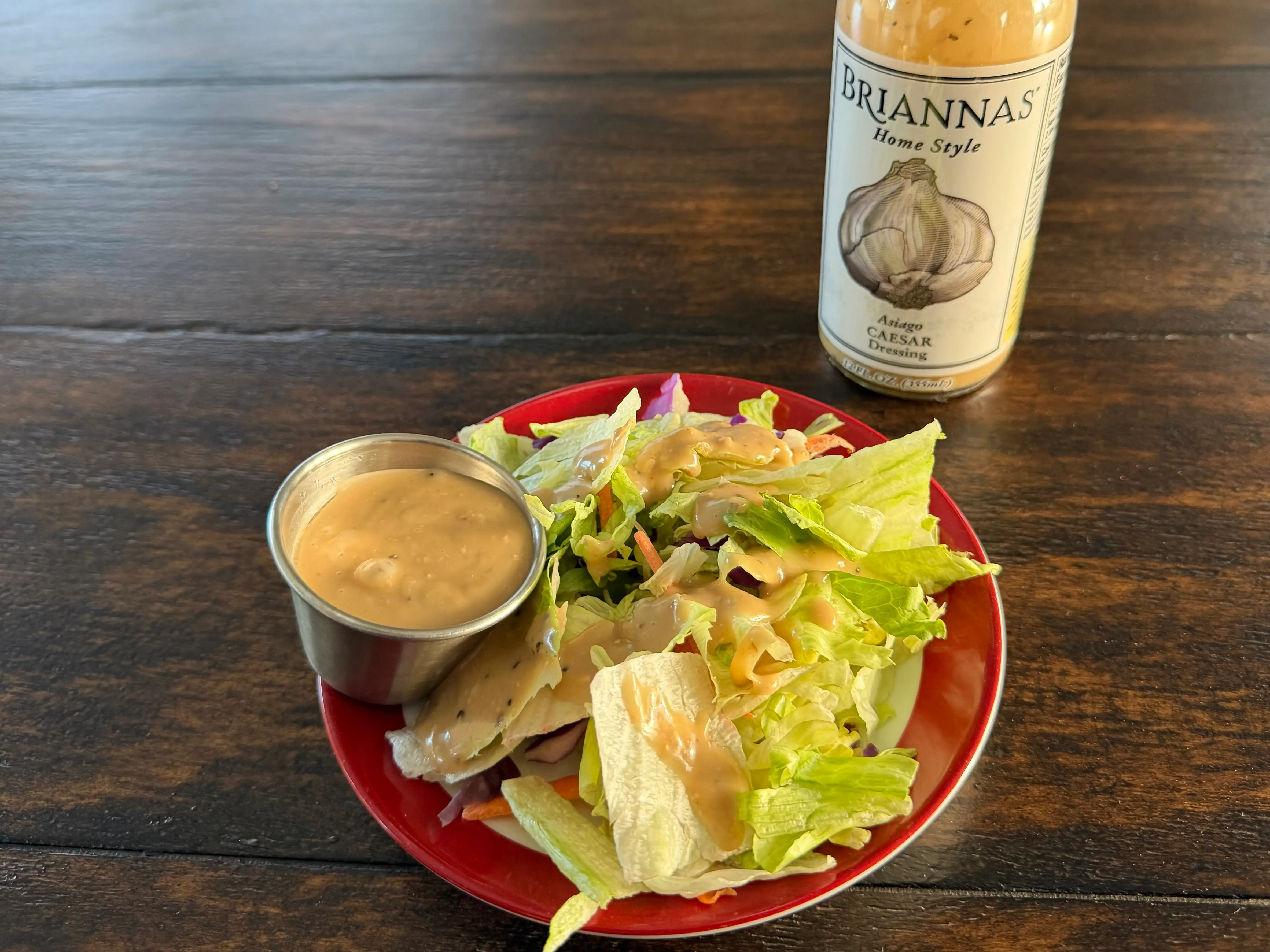 Brianna's Caesar dressing bottle next to small salad