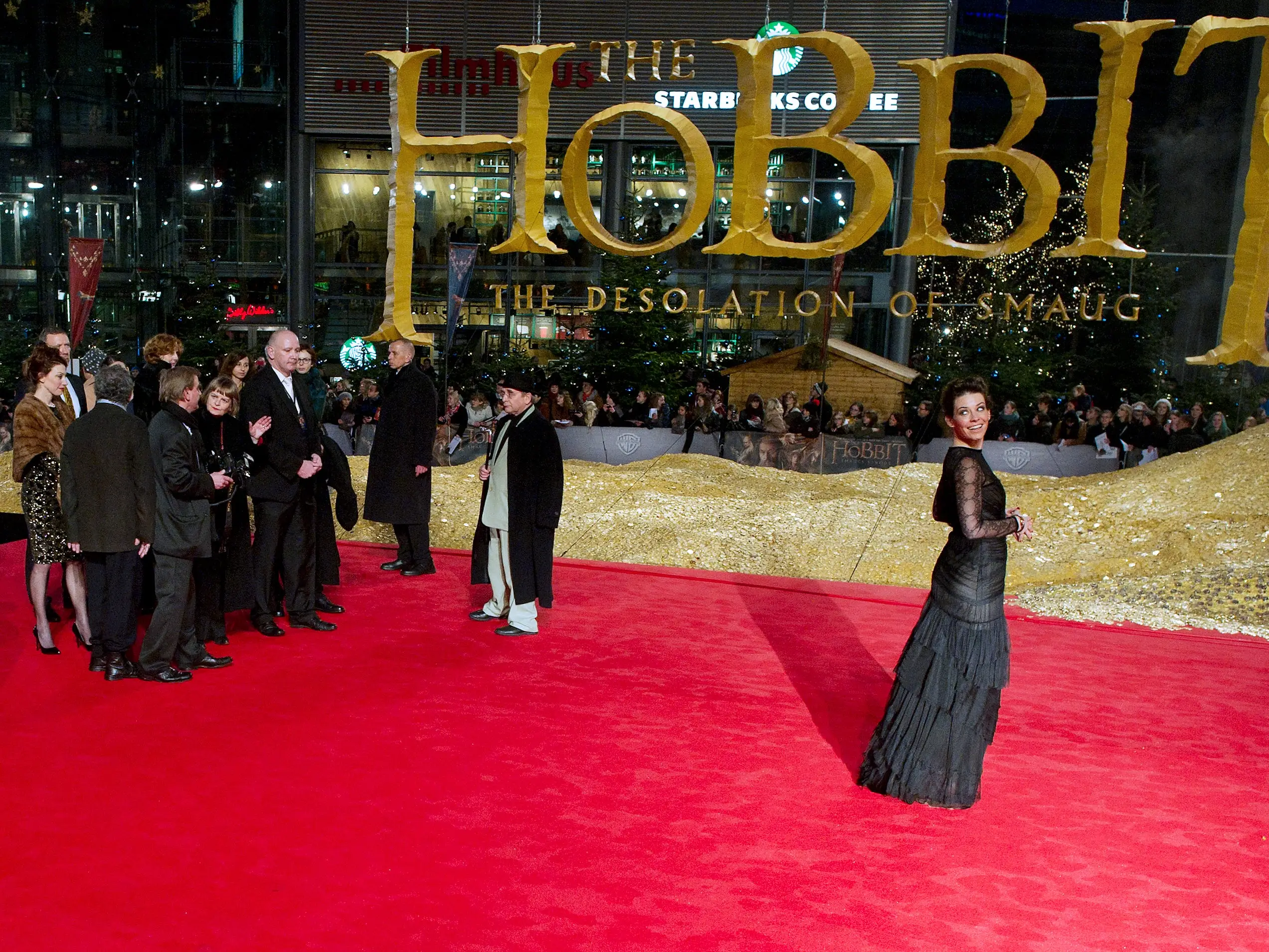An actress poses for a photo on a red carpet.