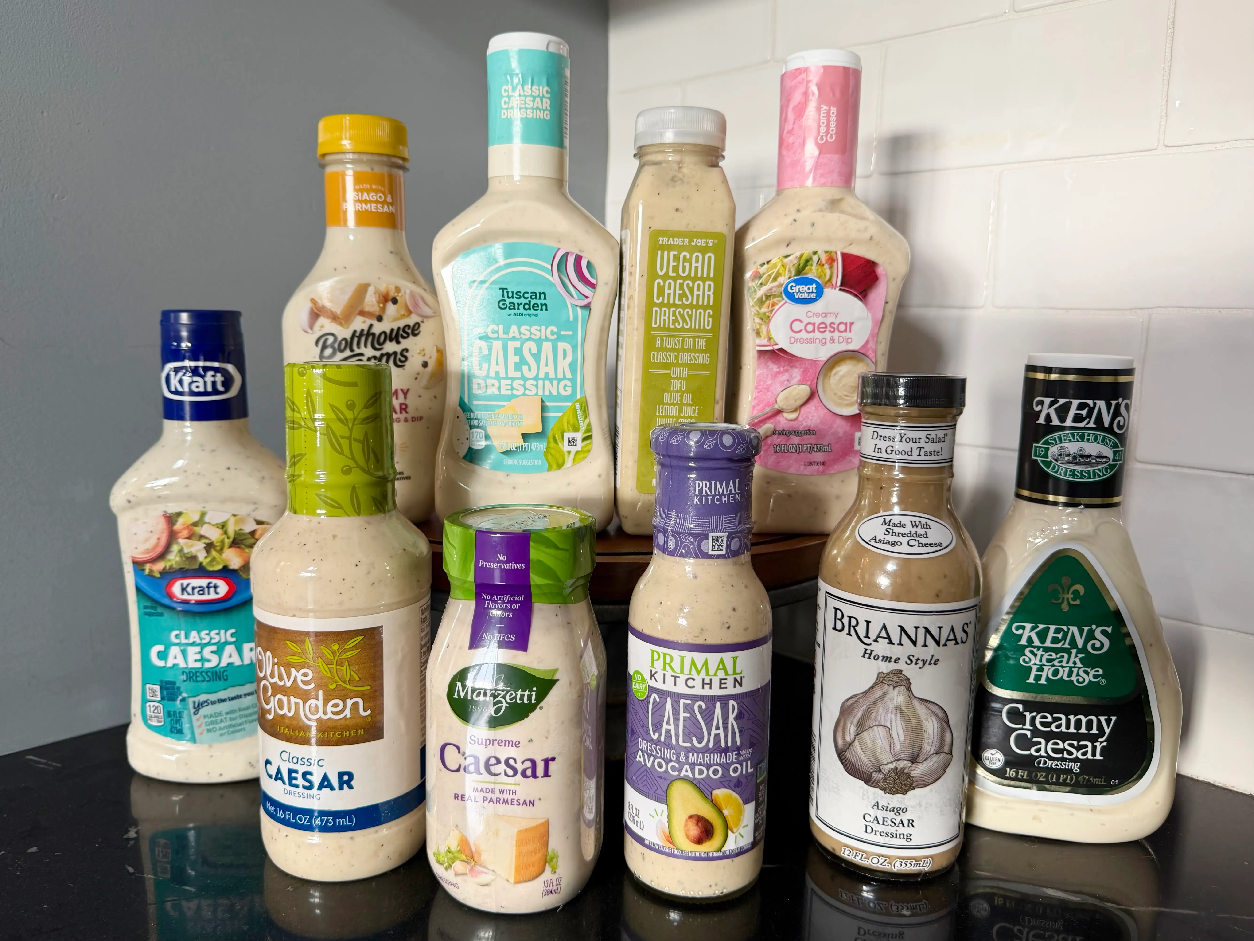 Group of Caesar dressings from Kraft, Olive Garden, Tuscan Garden, Primal Kitchen, Great Value, Bolthouse Farms, Brianna's, Ken''s, Marzetti