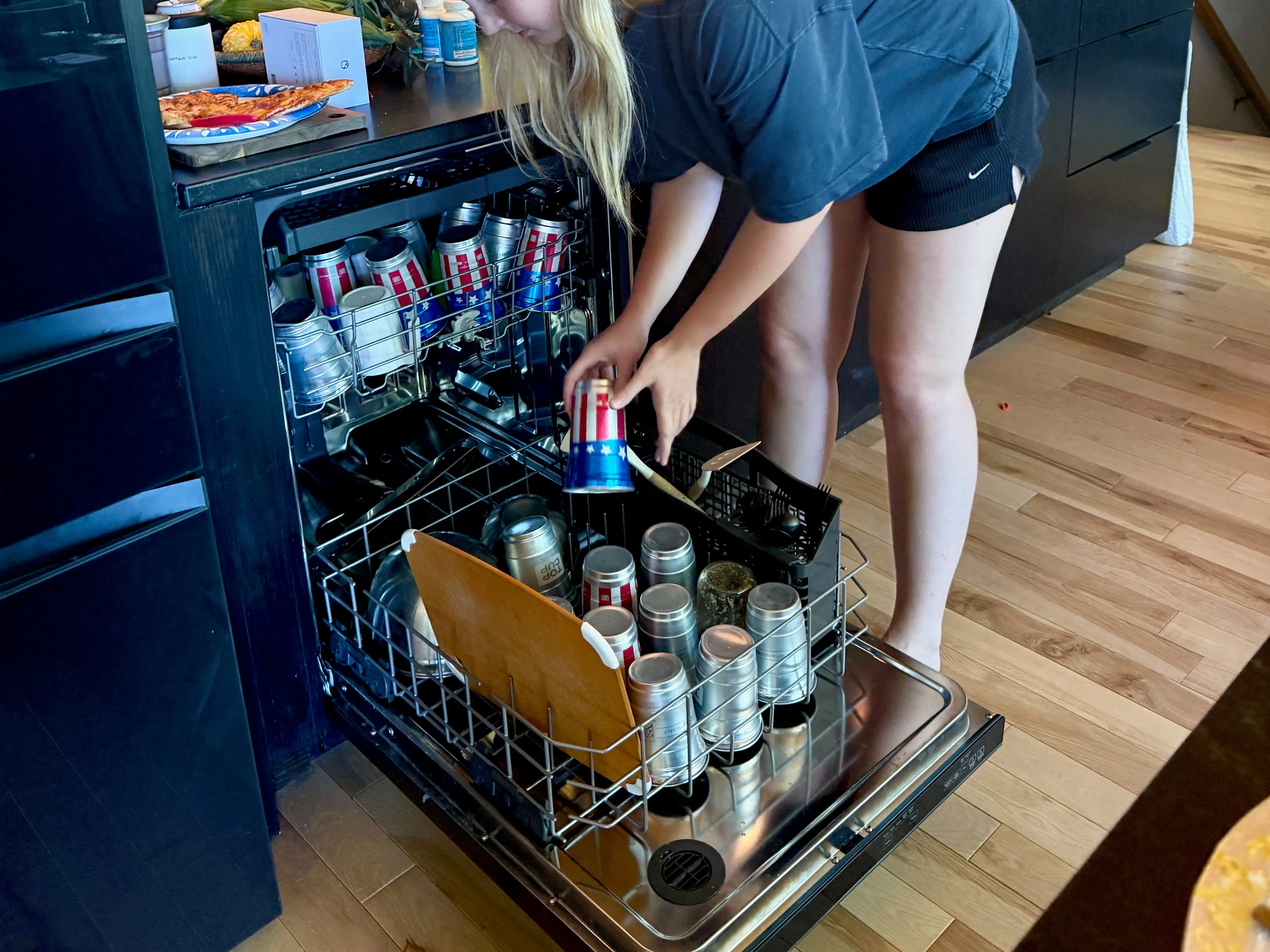 person putting drinks in cooler
