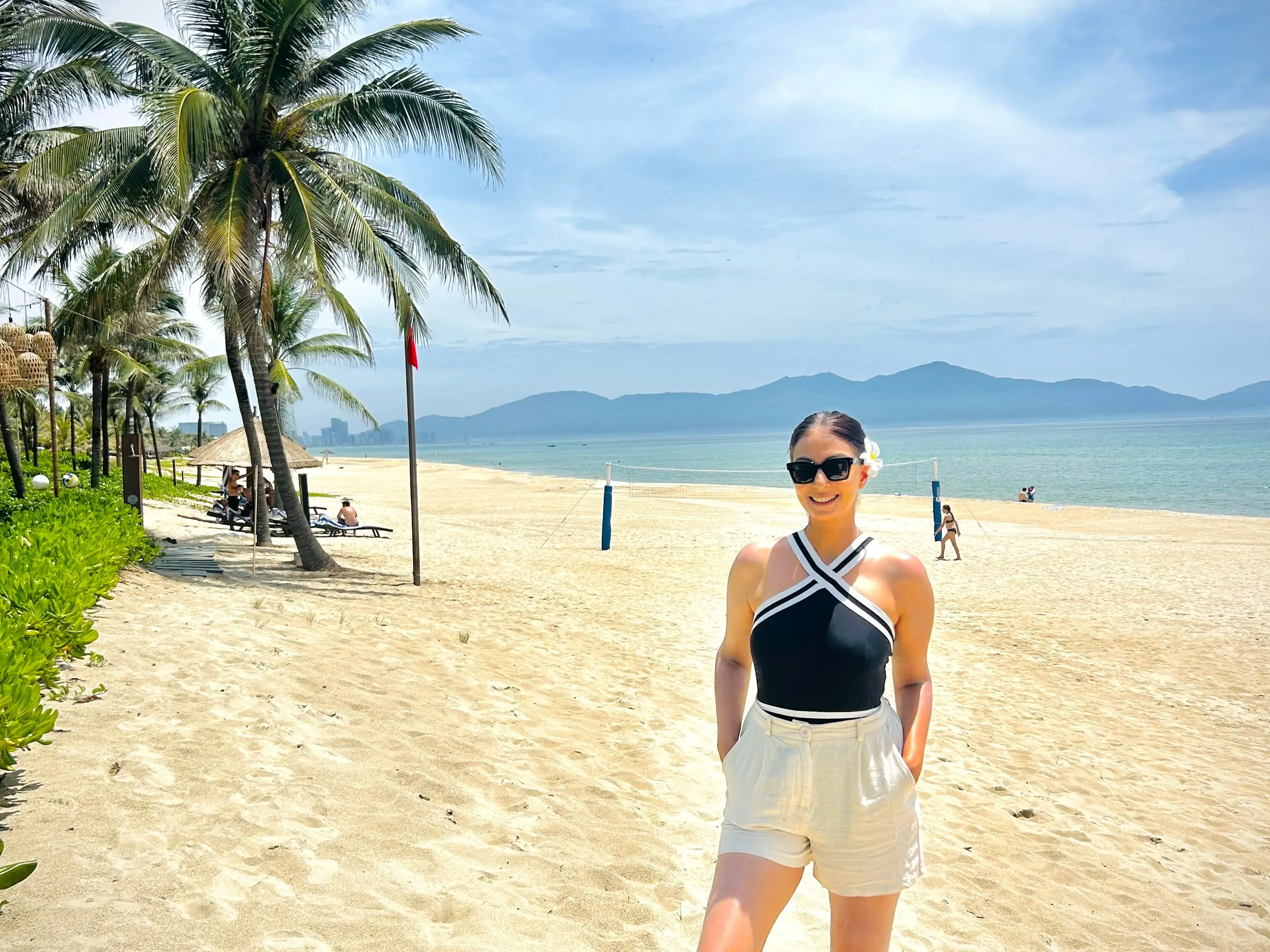 The writer standing on an empty beach in Da Nang, Vietnam.