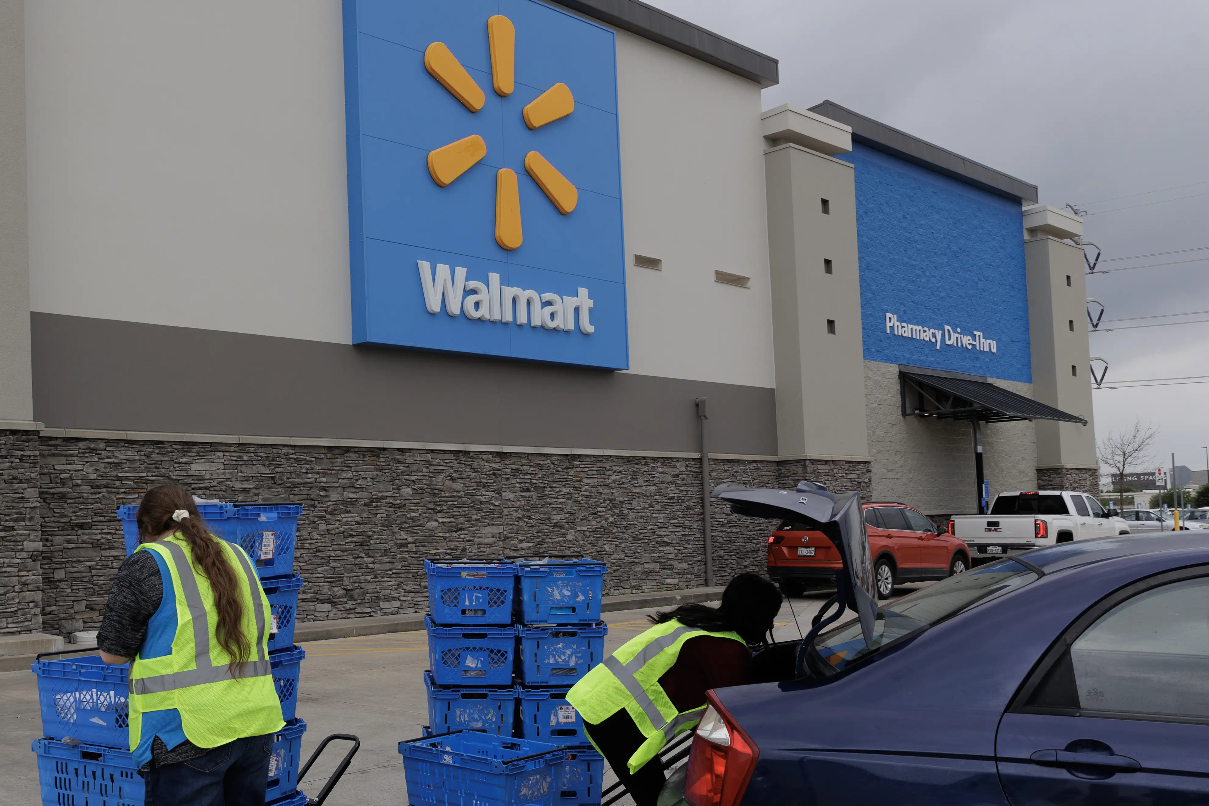 Employees unload online pickup orders at a Walmart store in Grand Prairie, Texas