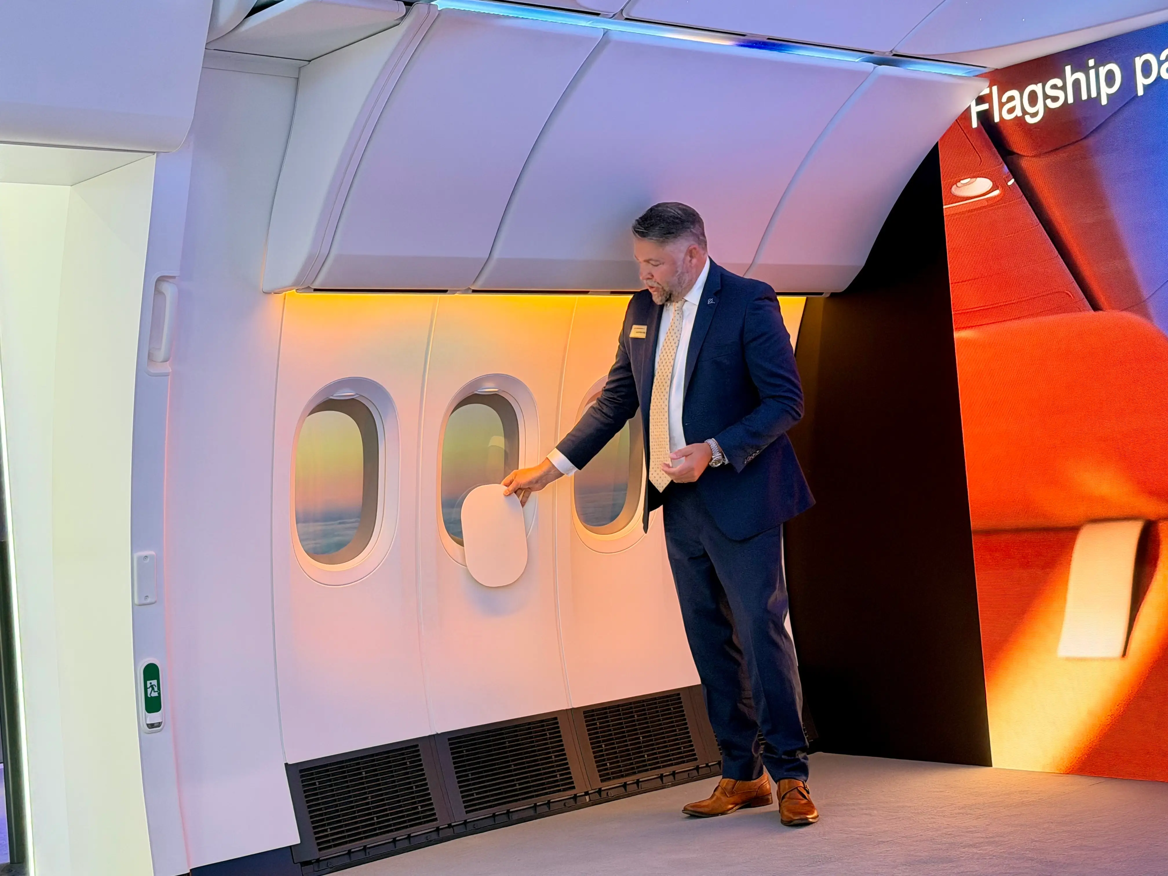 Boeing's Justin Hale demonstrating the difference in windows.