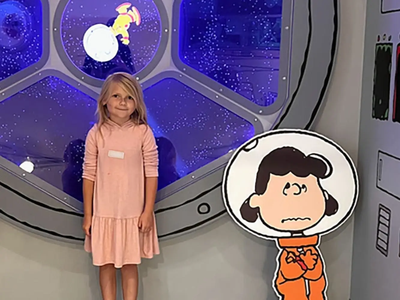Girls posing with Peanuts characters