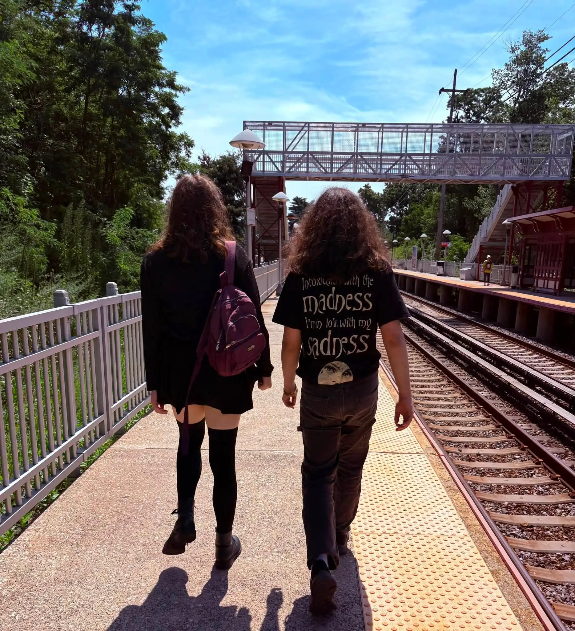 teenagers walking by train tracks
