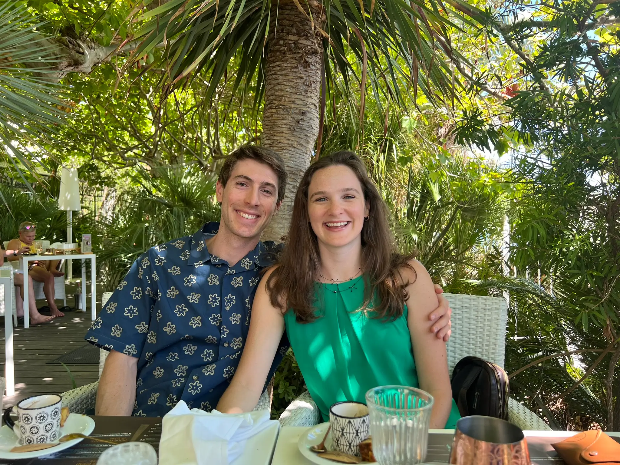 The couple poses while dining outside in a garden in Northern Italy.