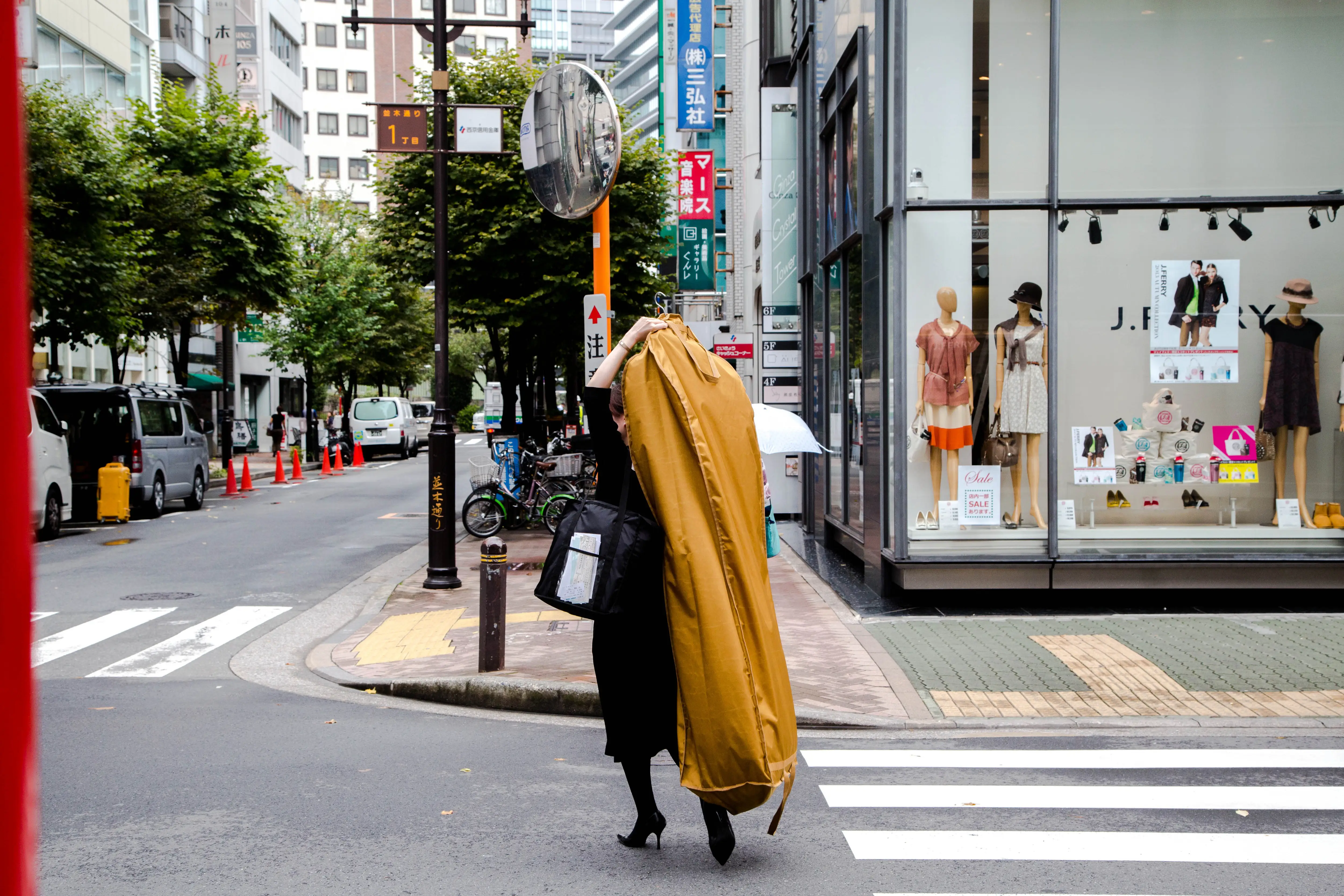 Woman carrying garment bag in Japan