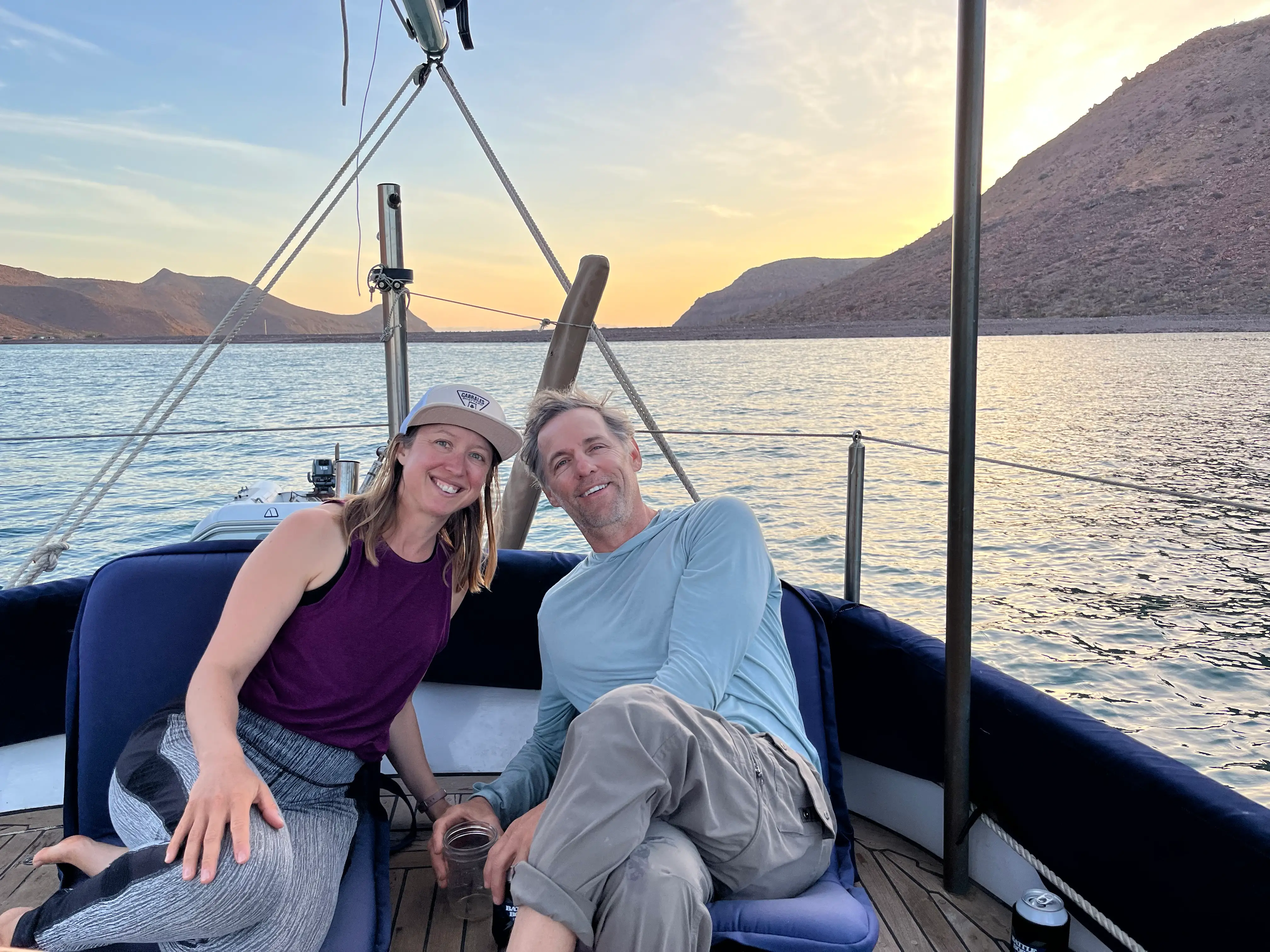 Man and woman smiling on sailboat