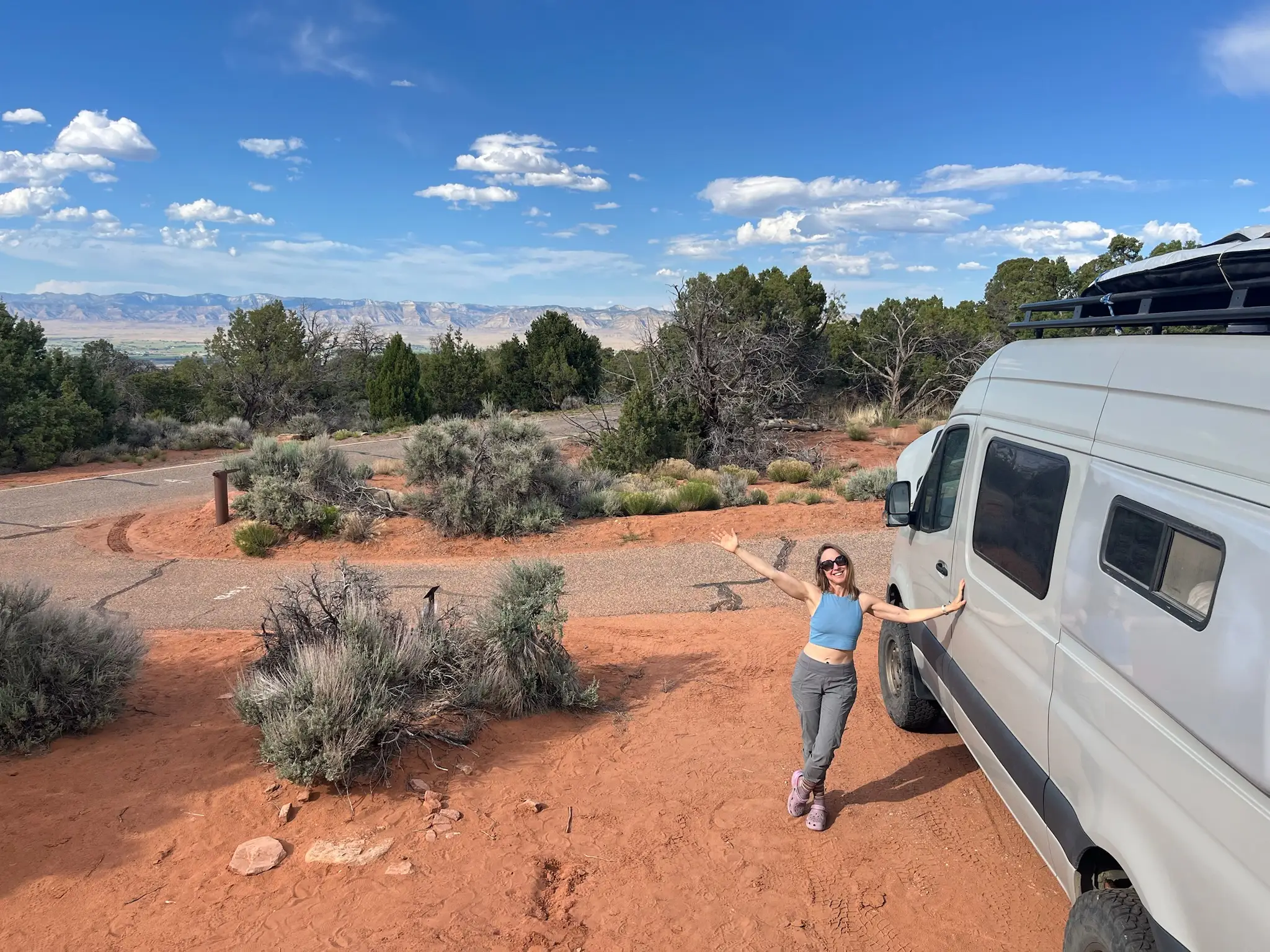 Woman posing with camper van