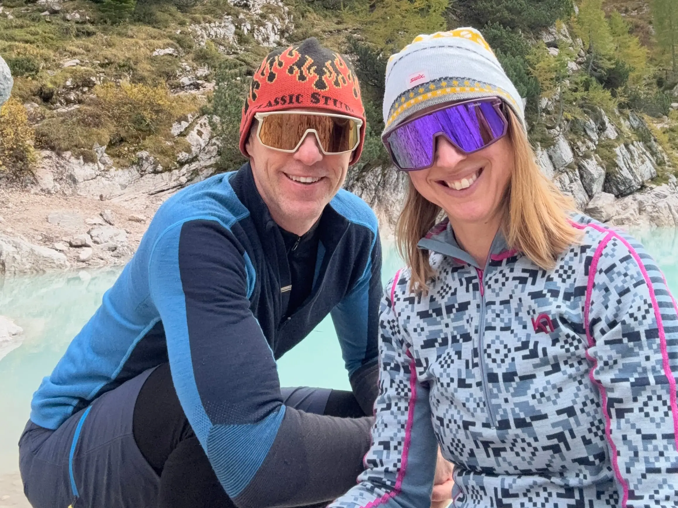 Man and woman smiling with goggles on