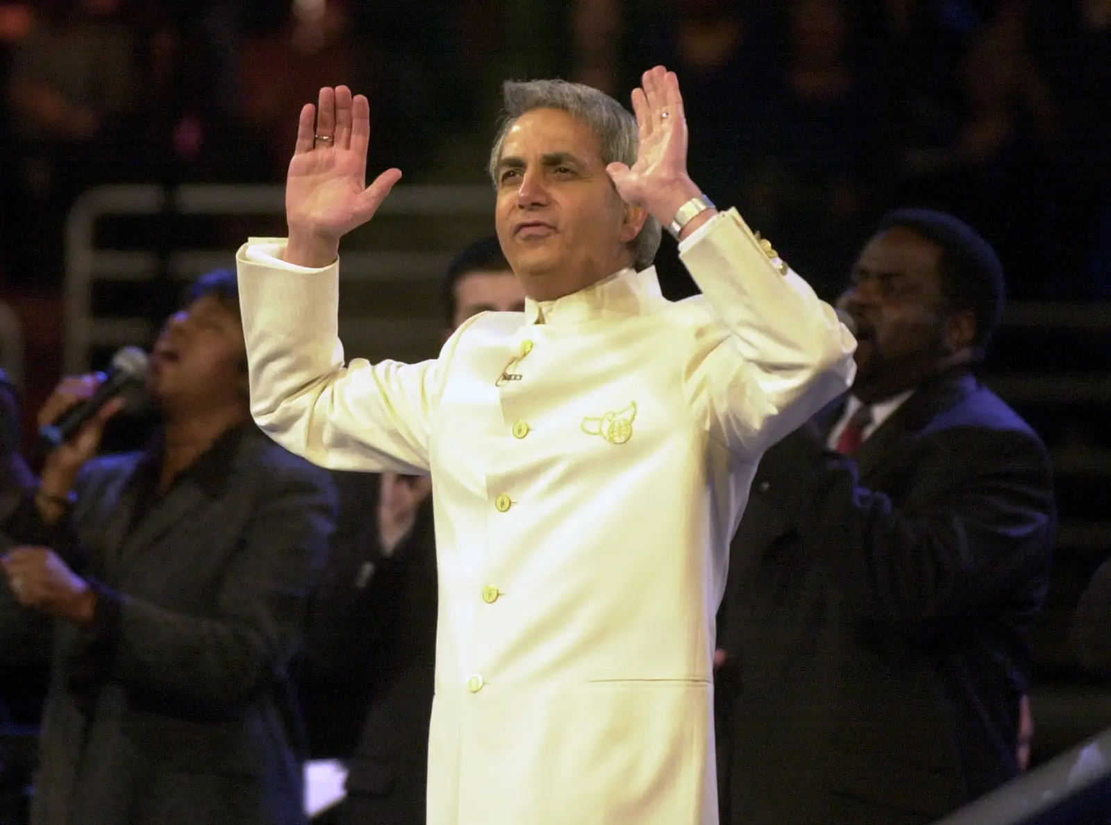 Faith healer Benny Hinn dressed in white suit during his Miracle Crusade at the Arrowhead Pond of Anaheim in 2003.